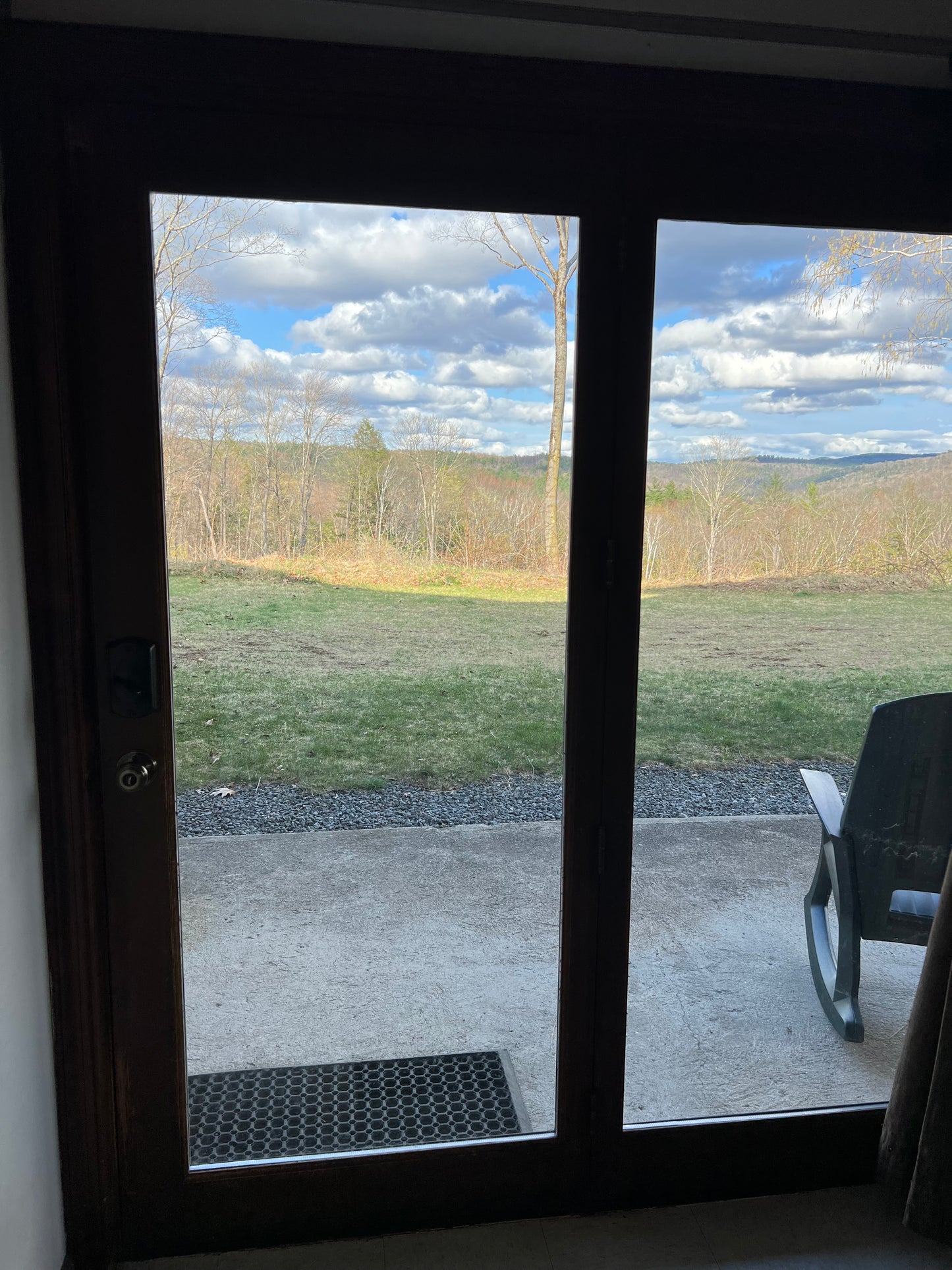 showing a landscape with grass and clouds, Looking out a full view glass door