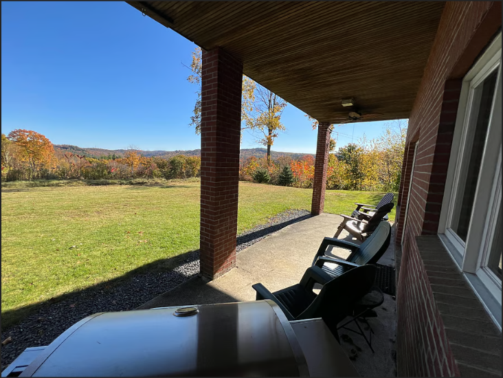 Patio in the back yard with  mountain views,  Nature View NH Estate