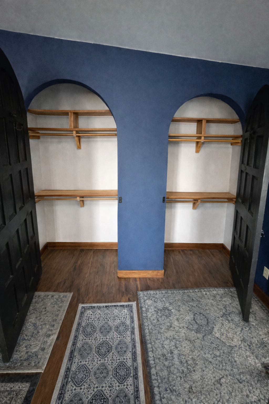 Closet with wooden shelves against a blue wall