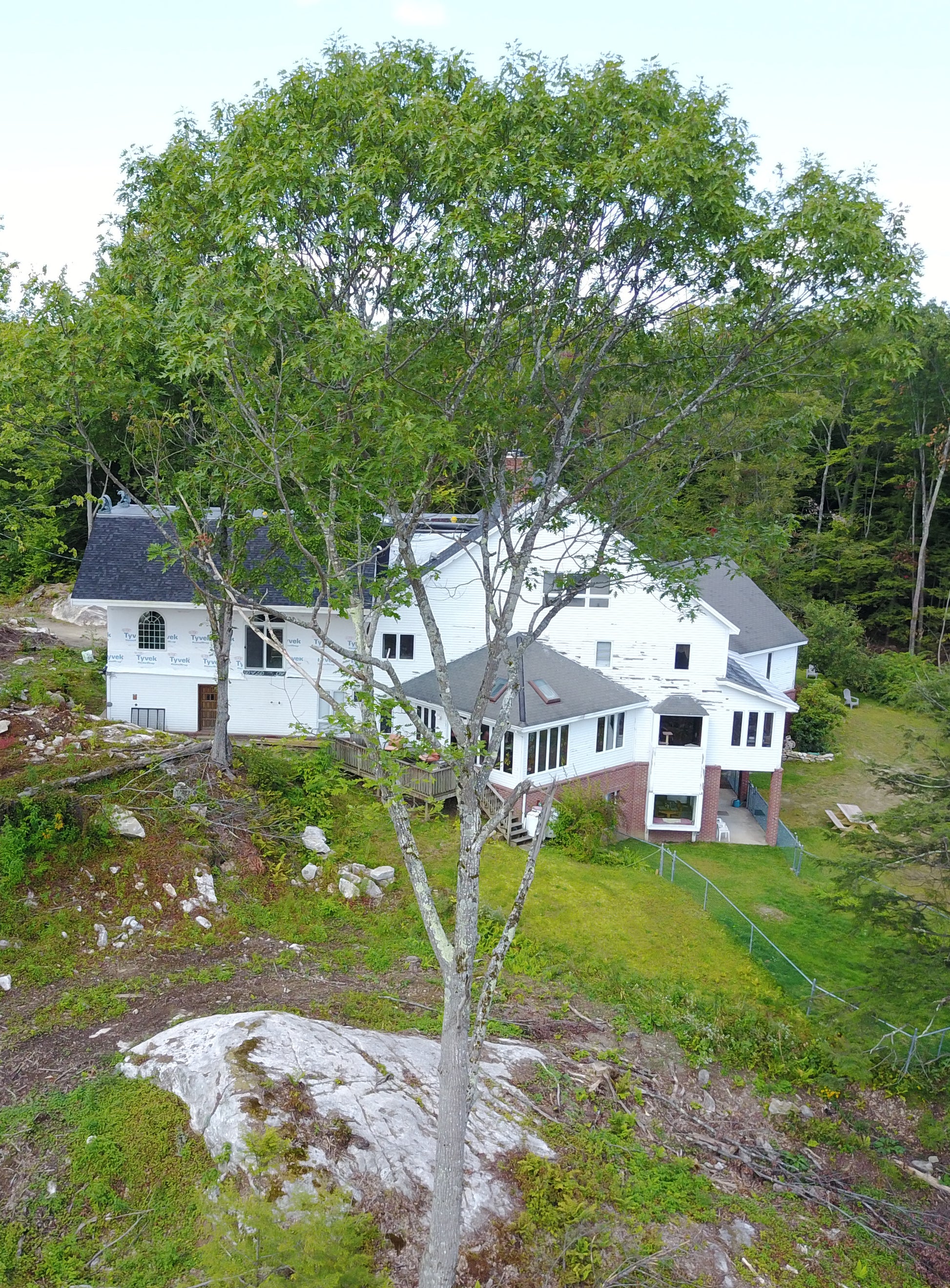 Nature View NH Estate with gray roofs surrounded by trees and greenery