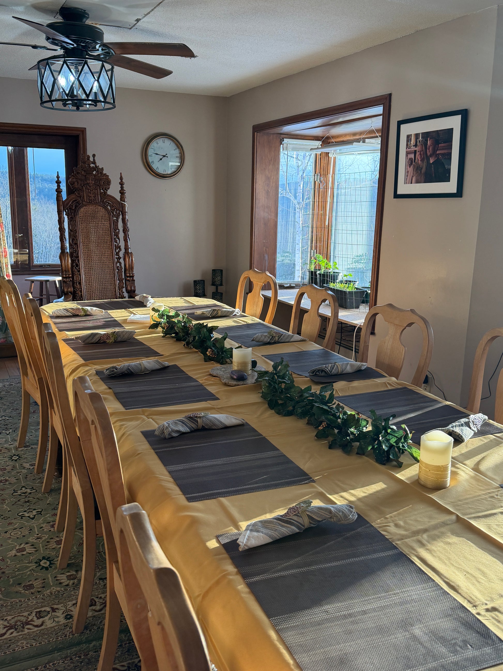 Dining room with wooden table, chairs, and decorative elements. Nature View NH Estate