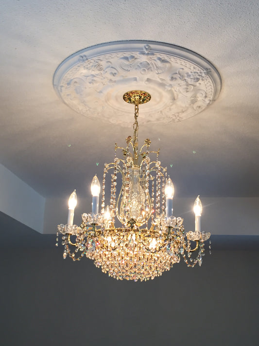 Crystal chandelier hanging against a white wall