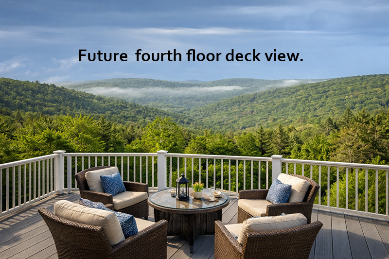 Sky deck with furniture and scenic view of mountains and trees.