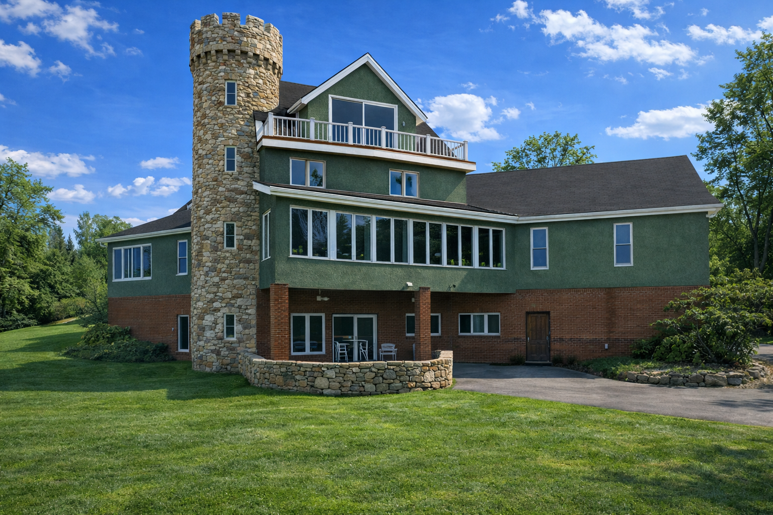 Large green house with a tower on a sunny day Nature View NH Estate