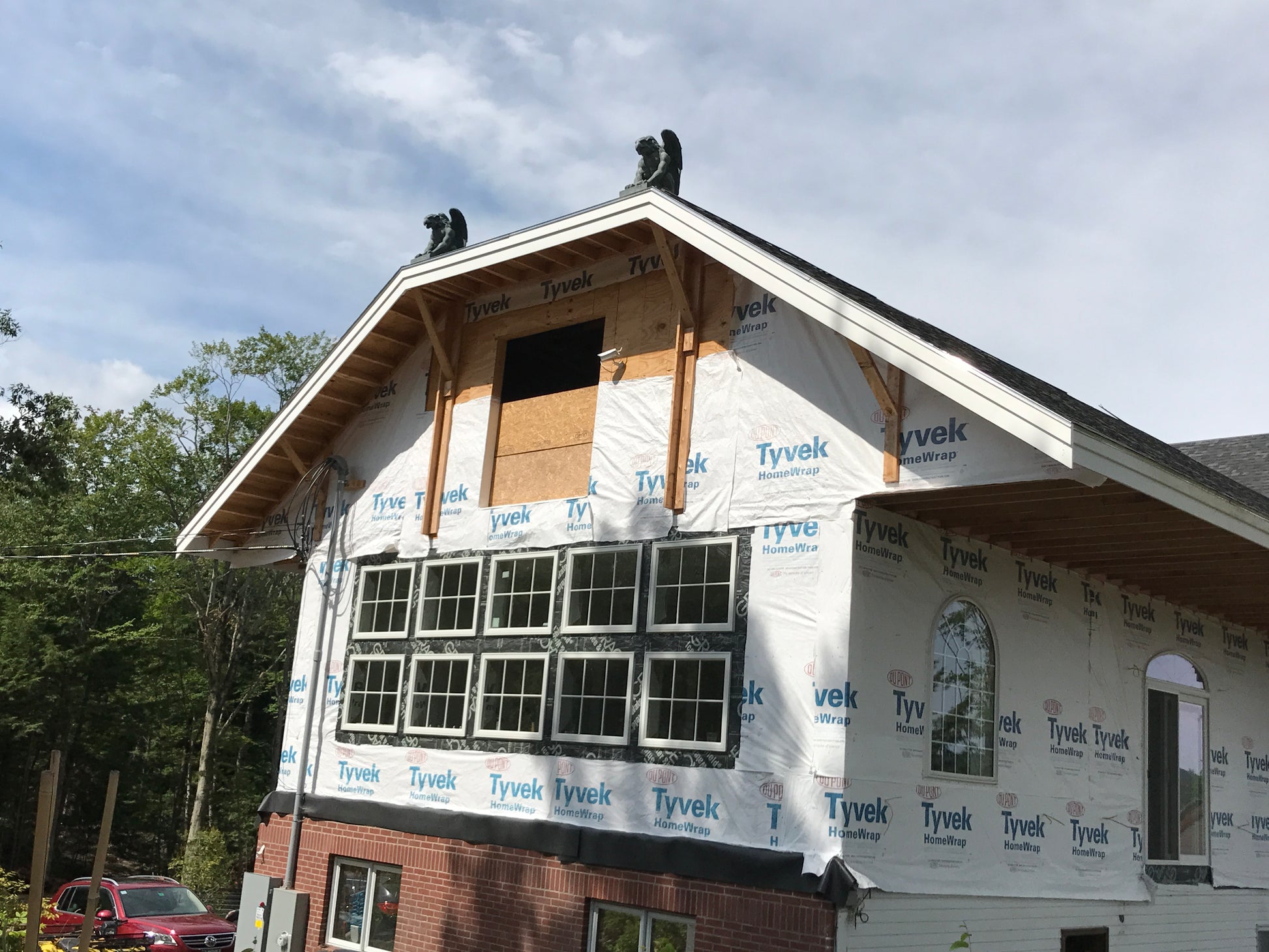 House under construction with Tyvek wrapping on a clear day