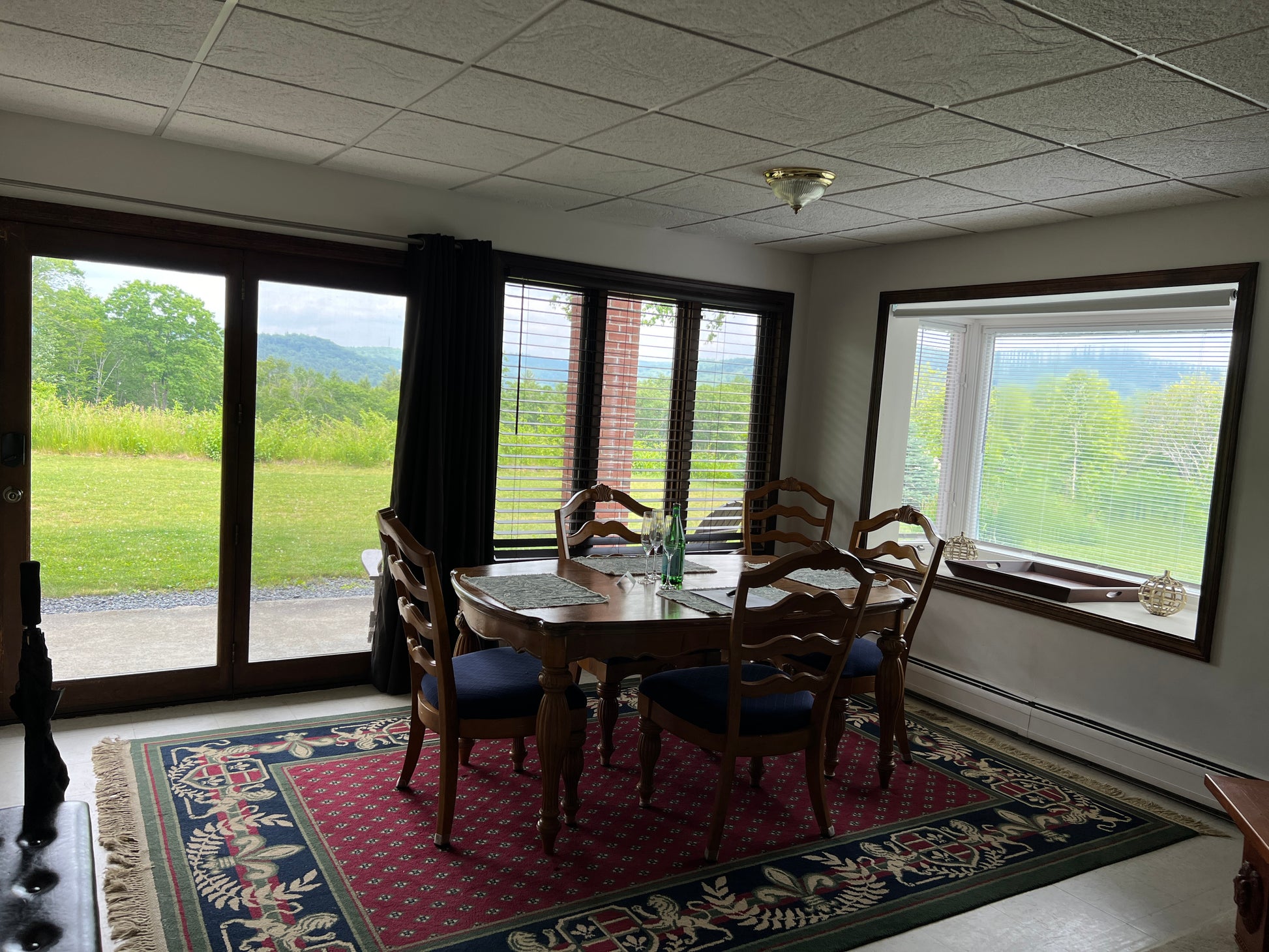 Dining room with a table and chairs near large windows with scenic view