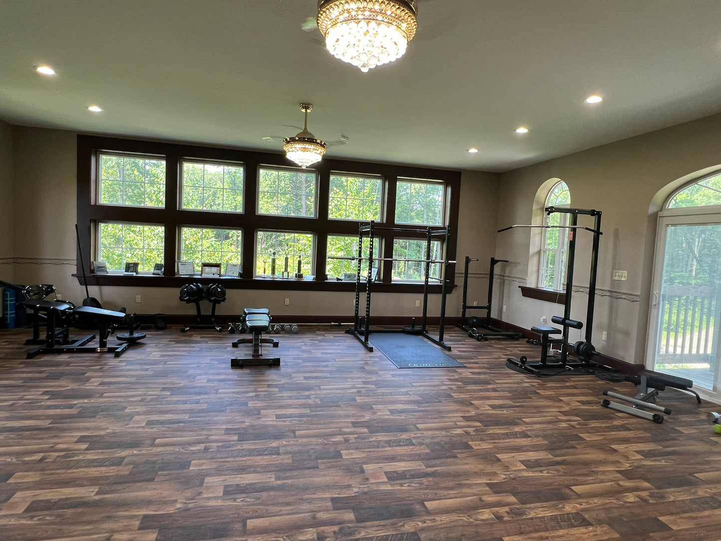 Gym interior with exercise equipment and large windows. Old world style gym