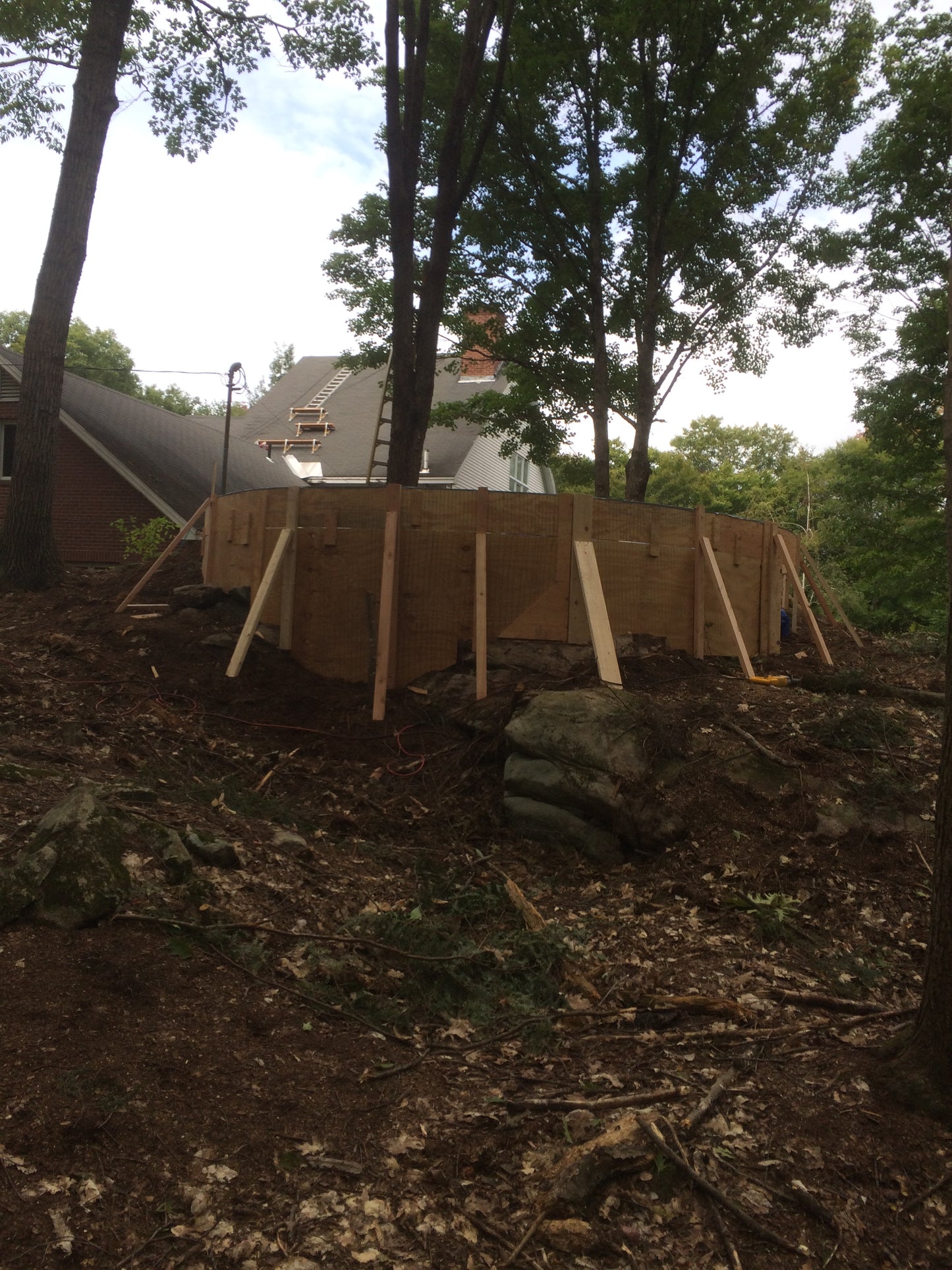 Building  of the fire pit Wooden structure being built in a wooded area