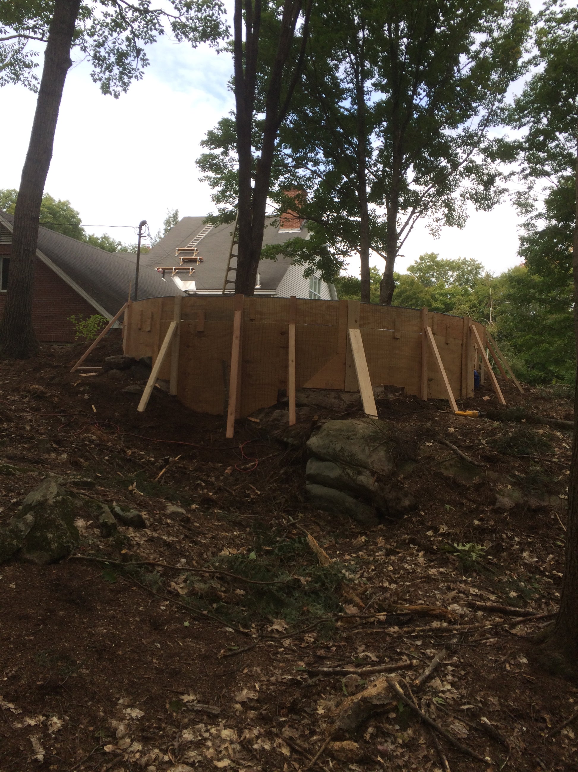 Building  of the fire pit Wooden structure being built in a wooded area