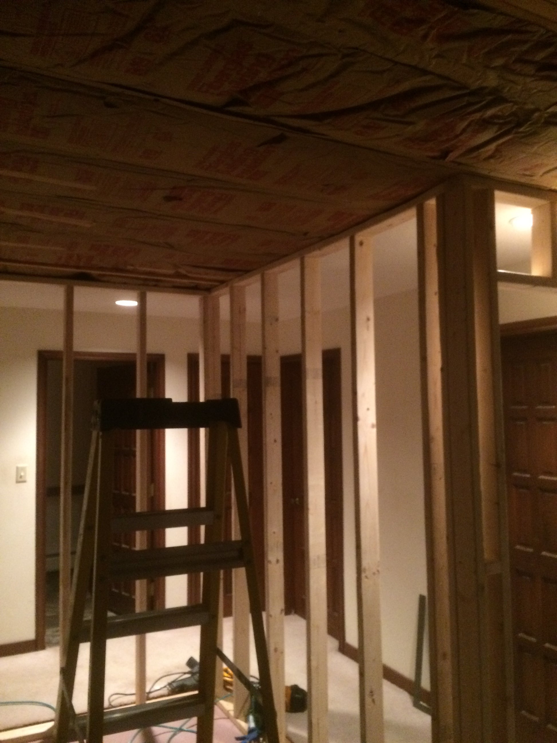 Under construction with a ladder in a dimly lit room