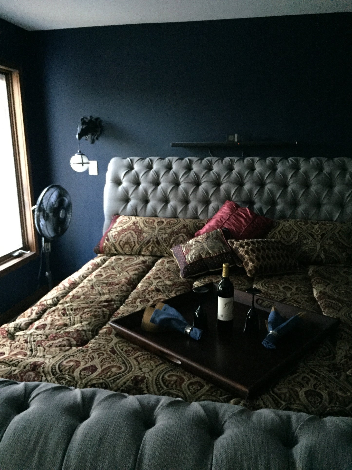 Top-down view of a room with a bed, romantic night wine and glasses and various items. Nature View NH Estate