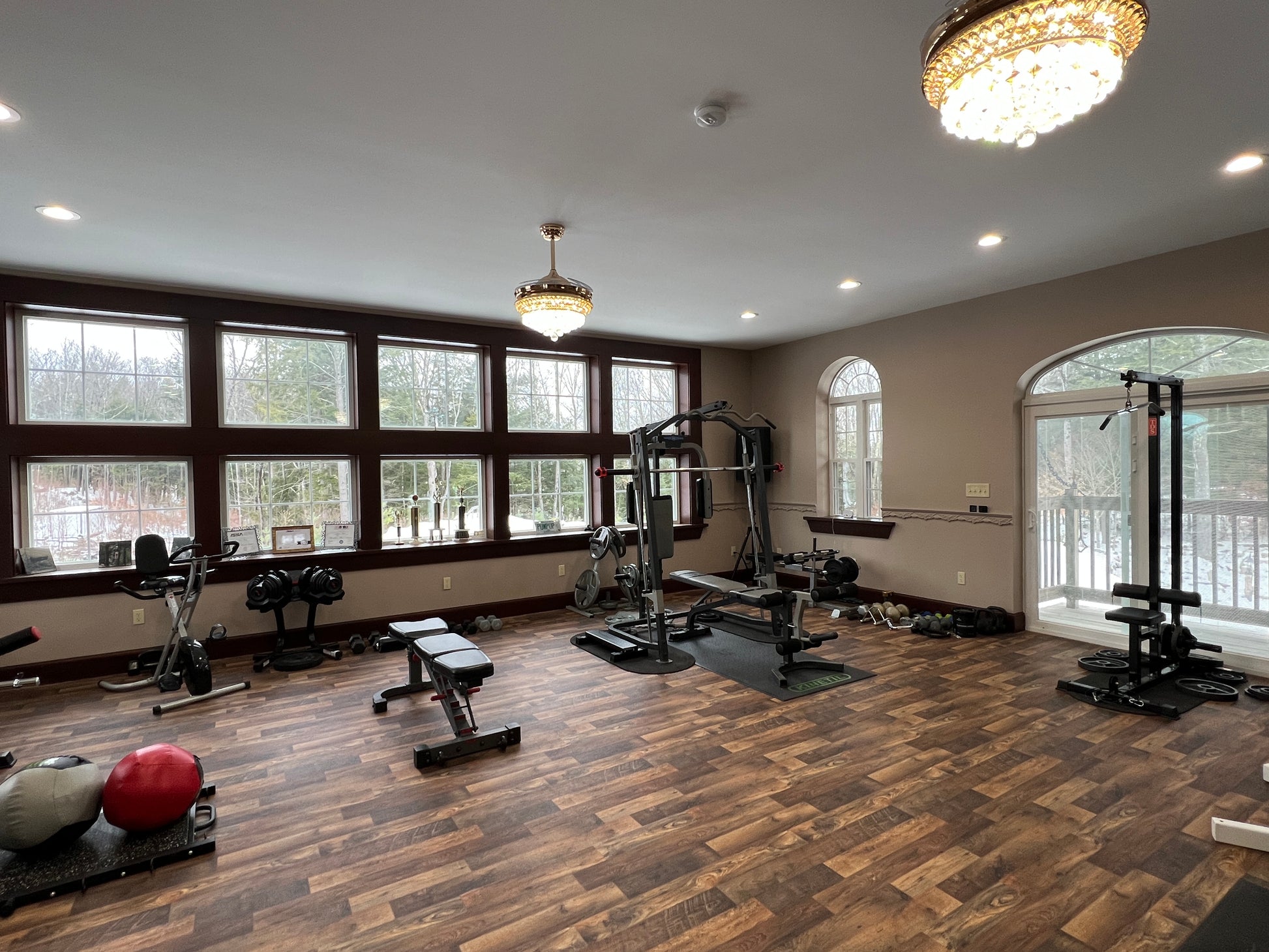 Gym luxury room  with various exercise equipment on a wooden floor. Fitness studio