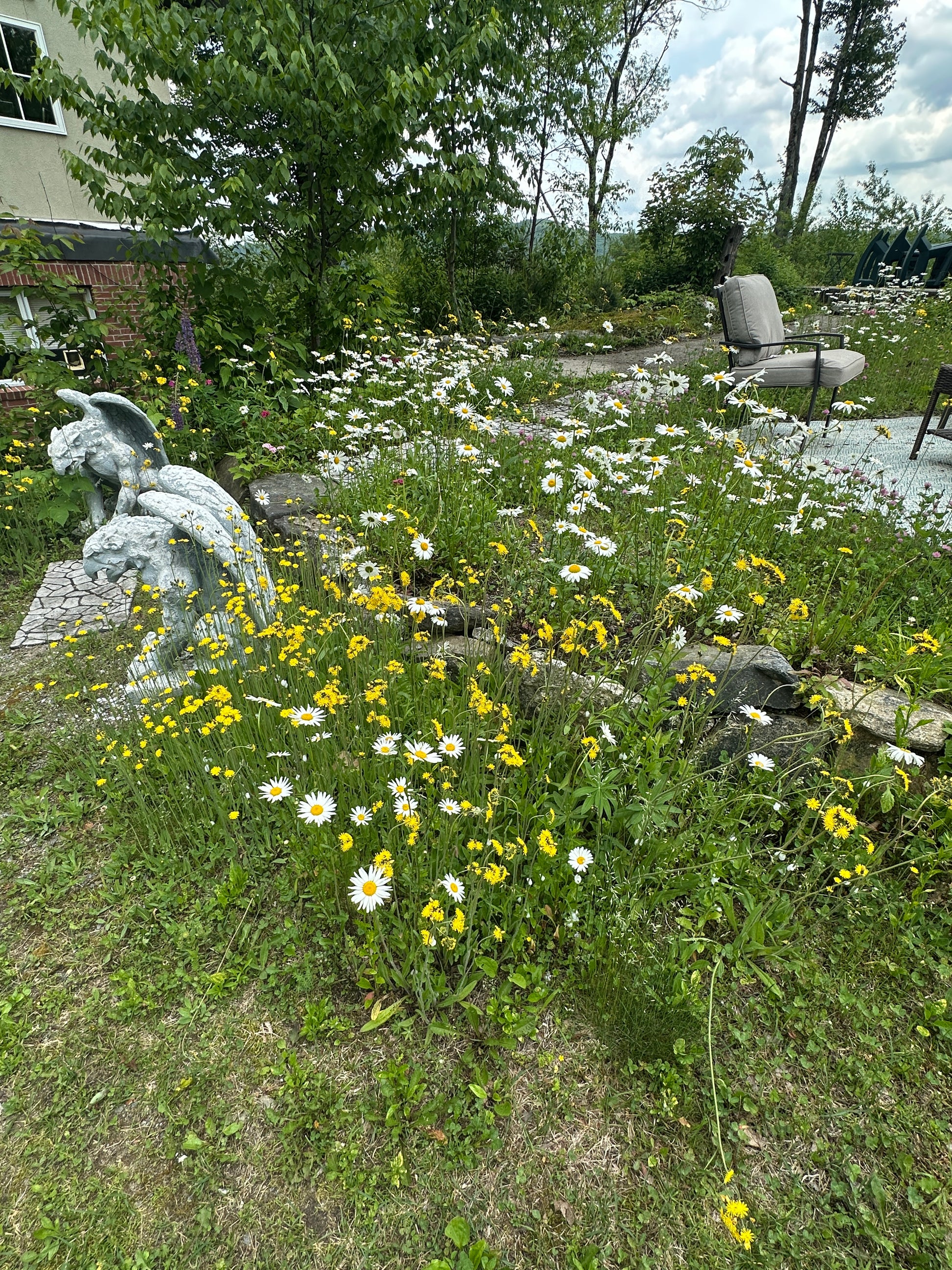 Statue in a garden with flowers and grass
