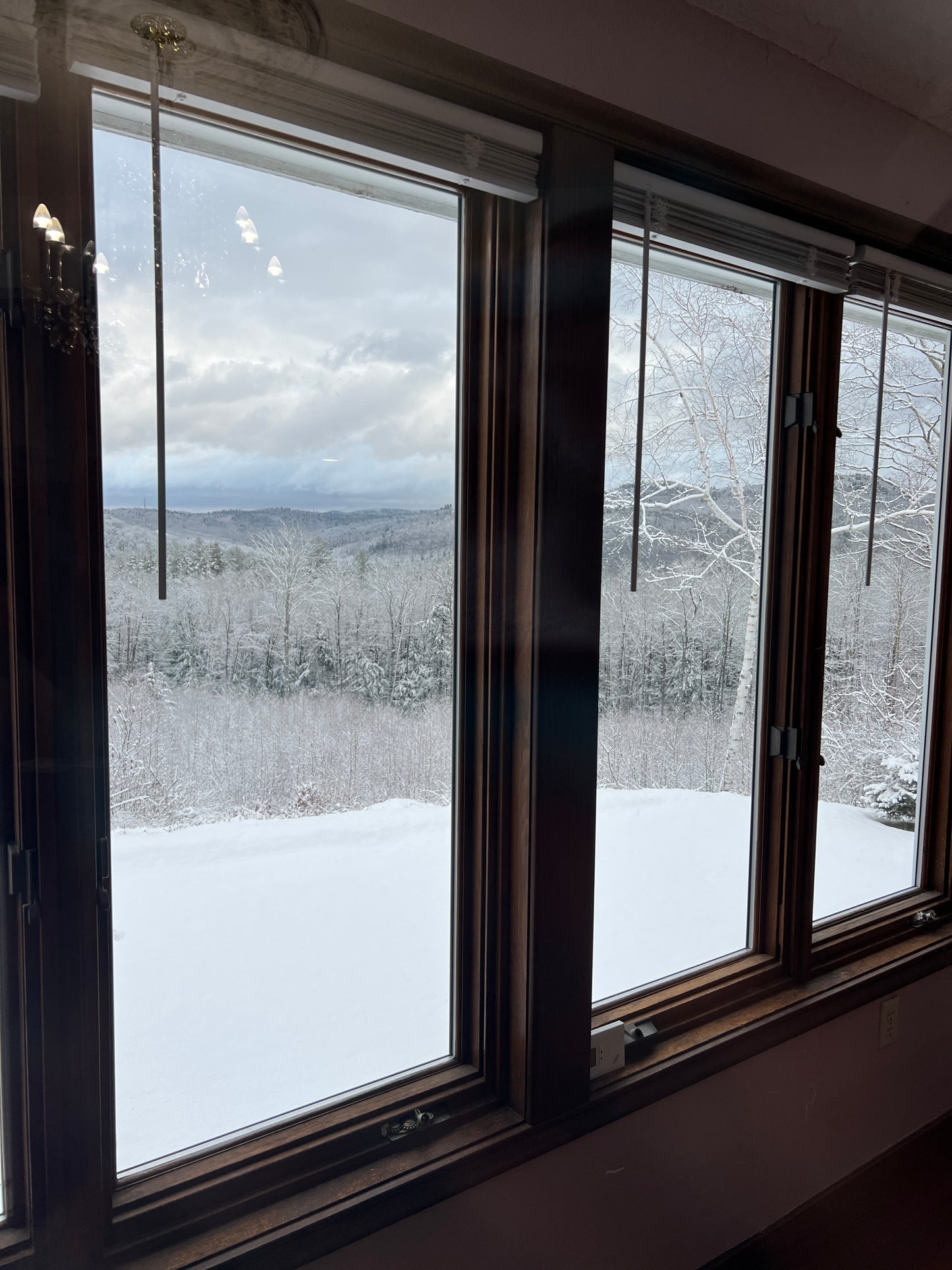 Two large windows with a view of a snowy landscape outside.