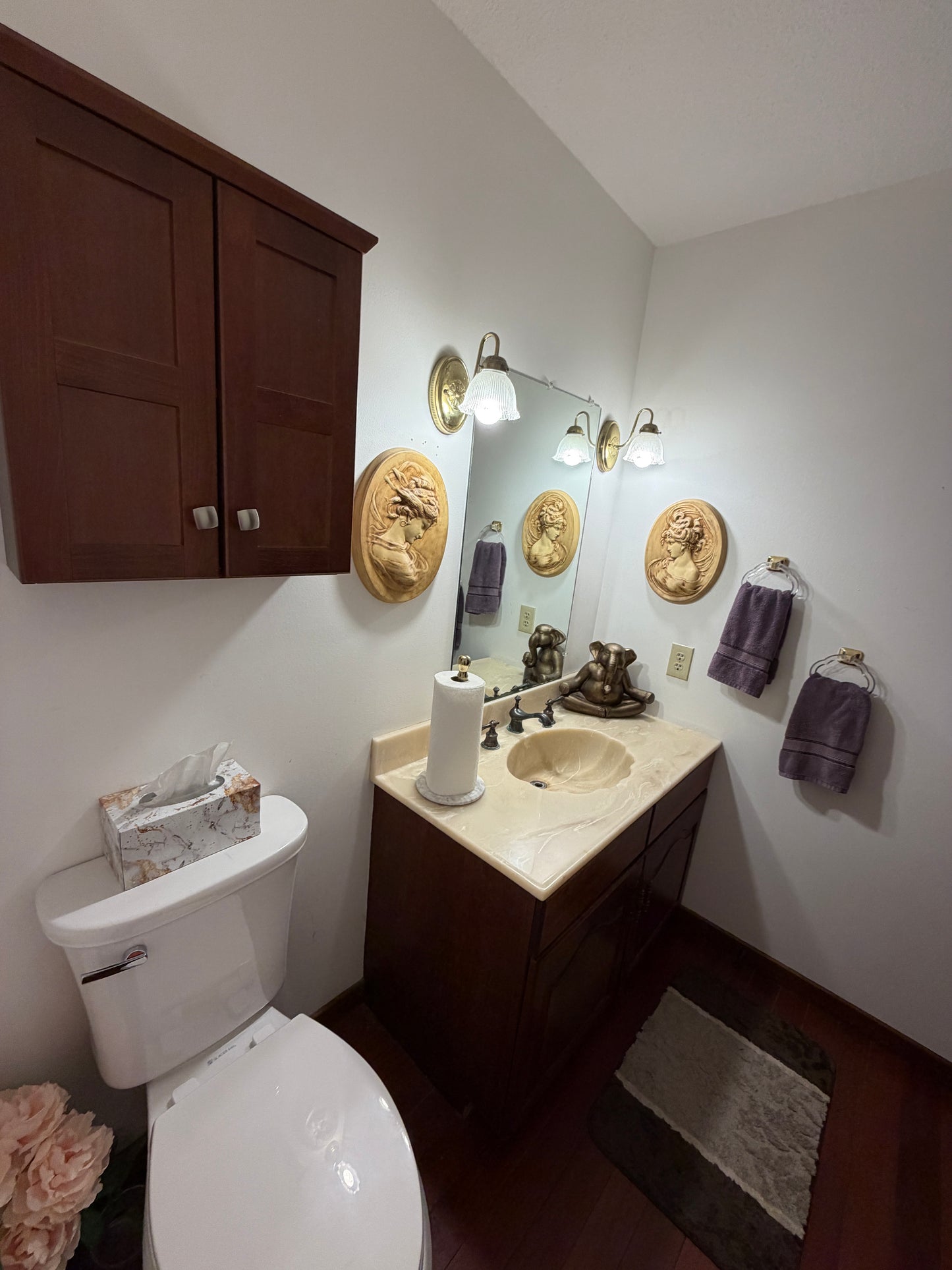 Top-down view of a bathroom vanity with mirror, sink, and various items.