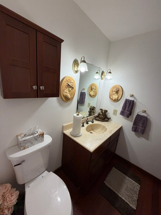 Top-down view of a bathroom vanity with mirror, sink, and various items.