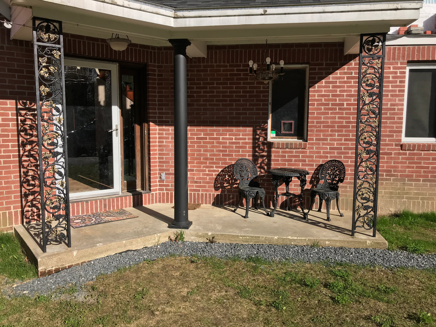 Patio with outdoor furniture under a brick building