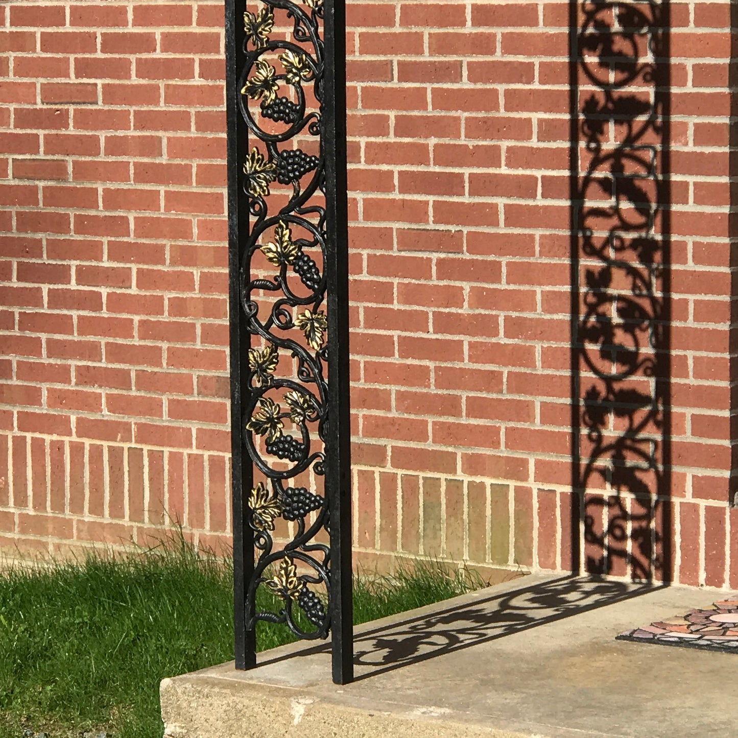 Decorative black wrought iron metal posts on a brick entranceway Nature View NH Estate