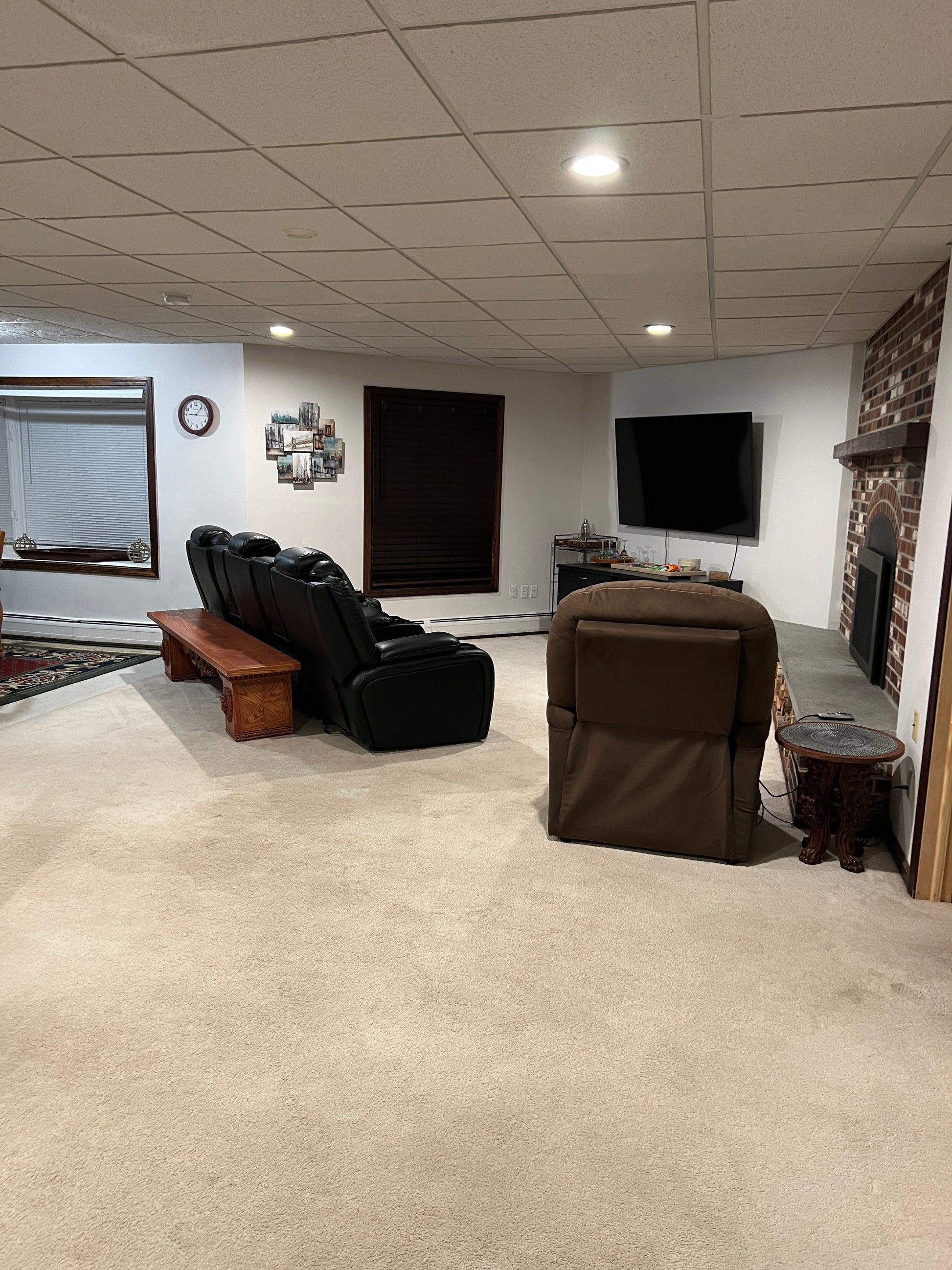 Living room with brown sofa, coffee table, and wall decor.
