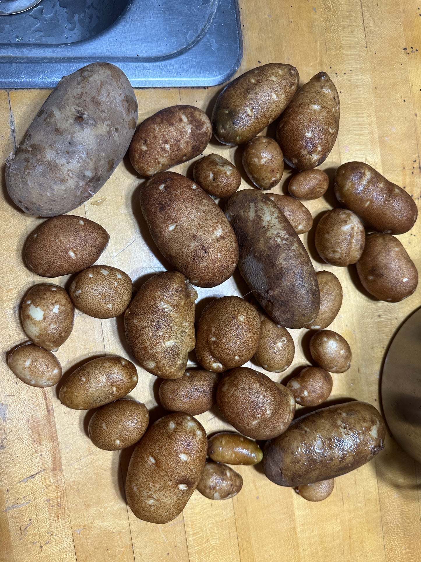Raw potatoes on a wooden surface
