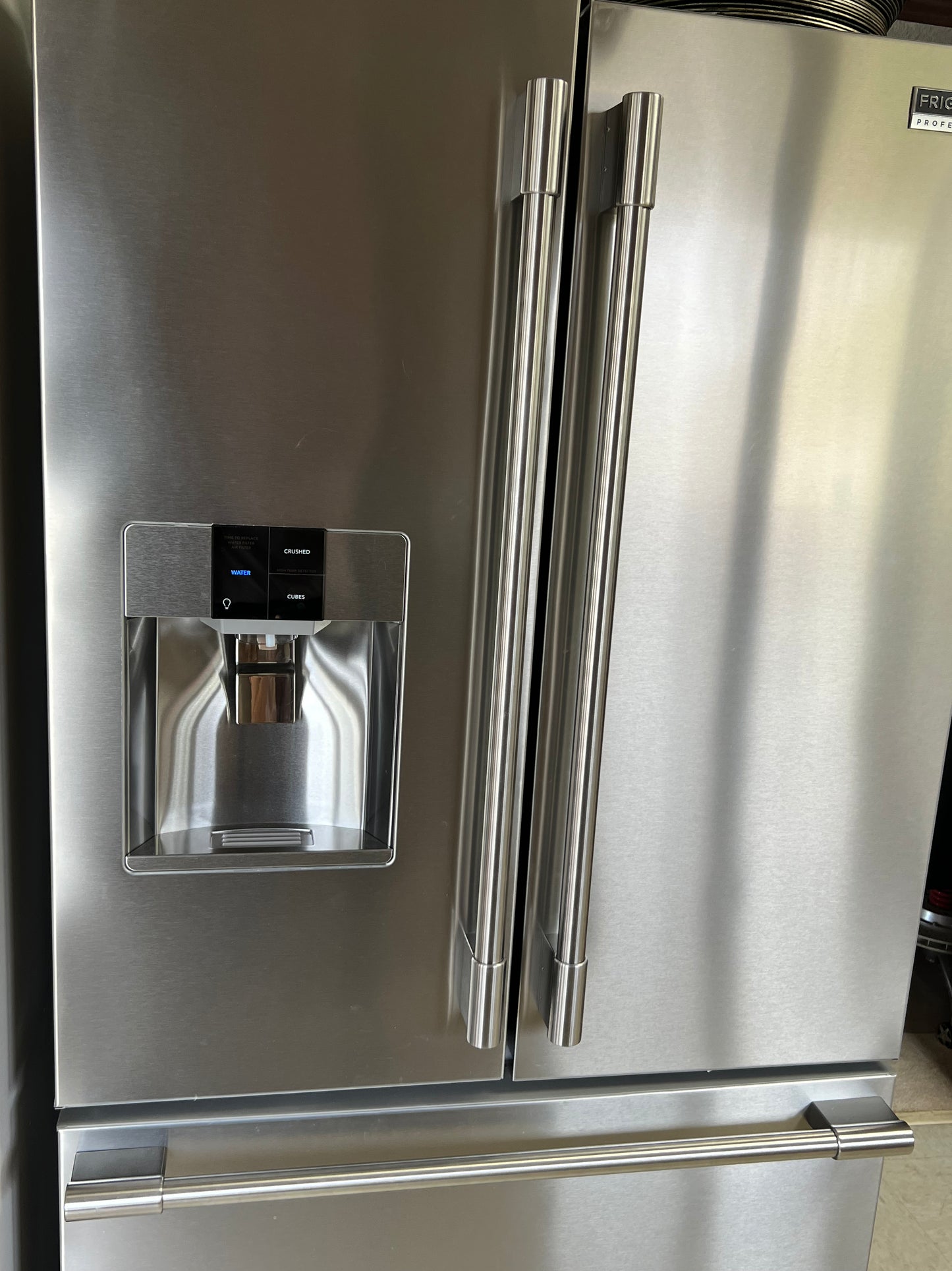Stainless steel refrigerator with water and ice dispenser