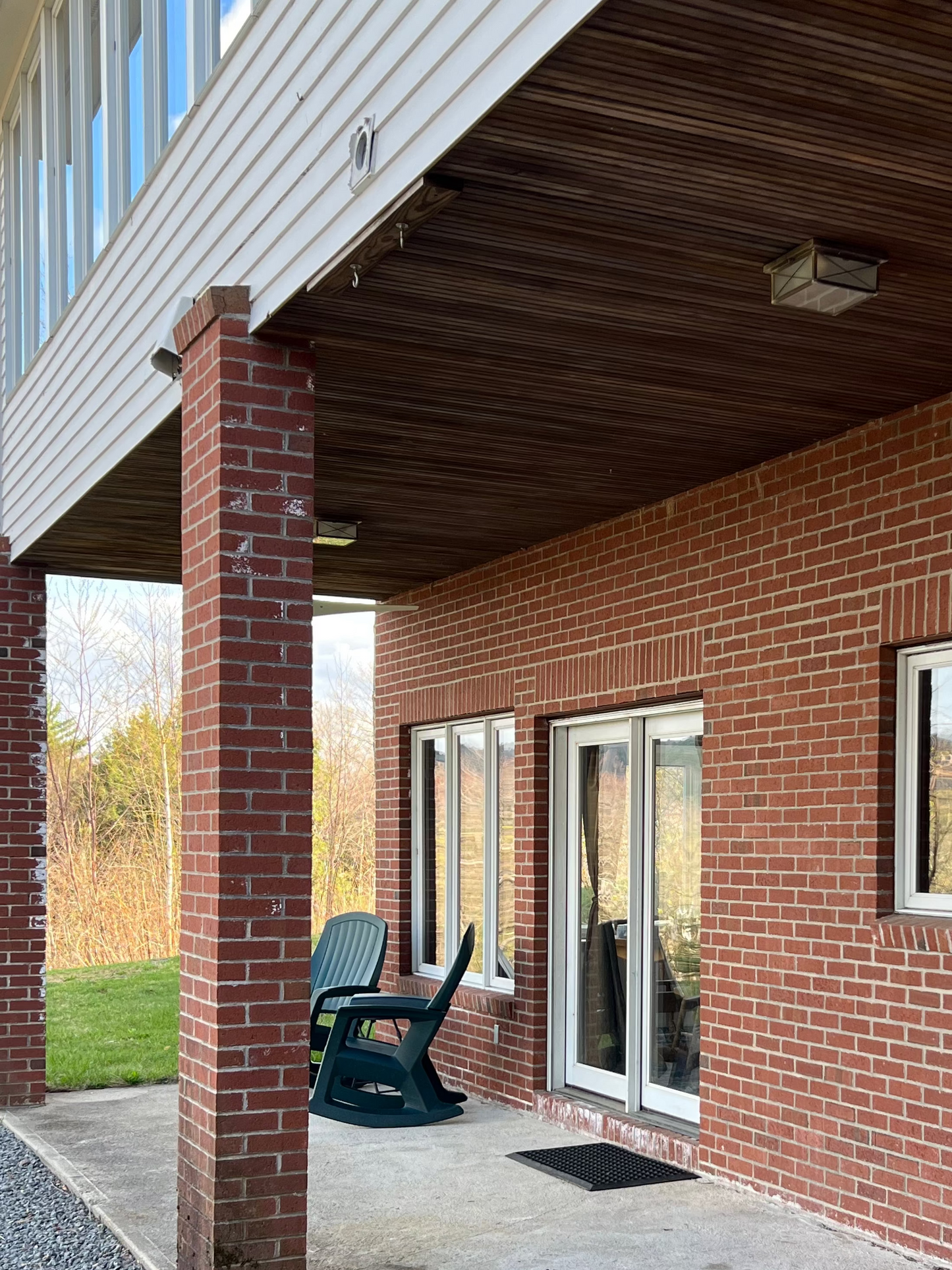 Brick building exterior with a covered porch and windows
