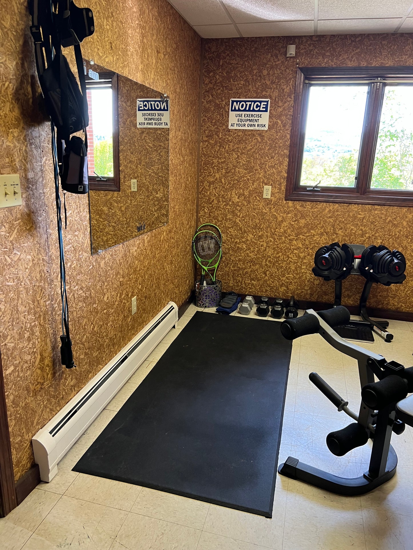 Gym room with exercise equipment on cork flooring