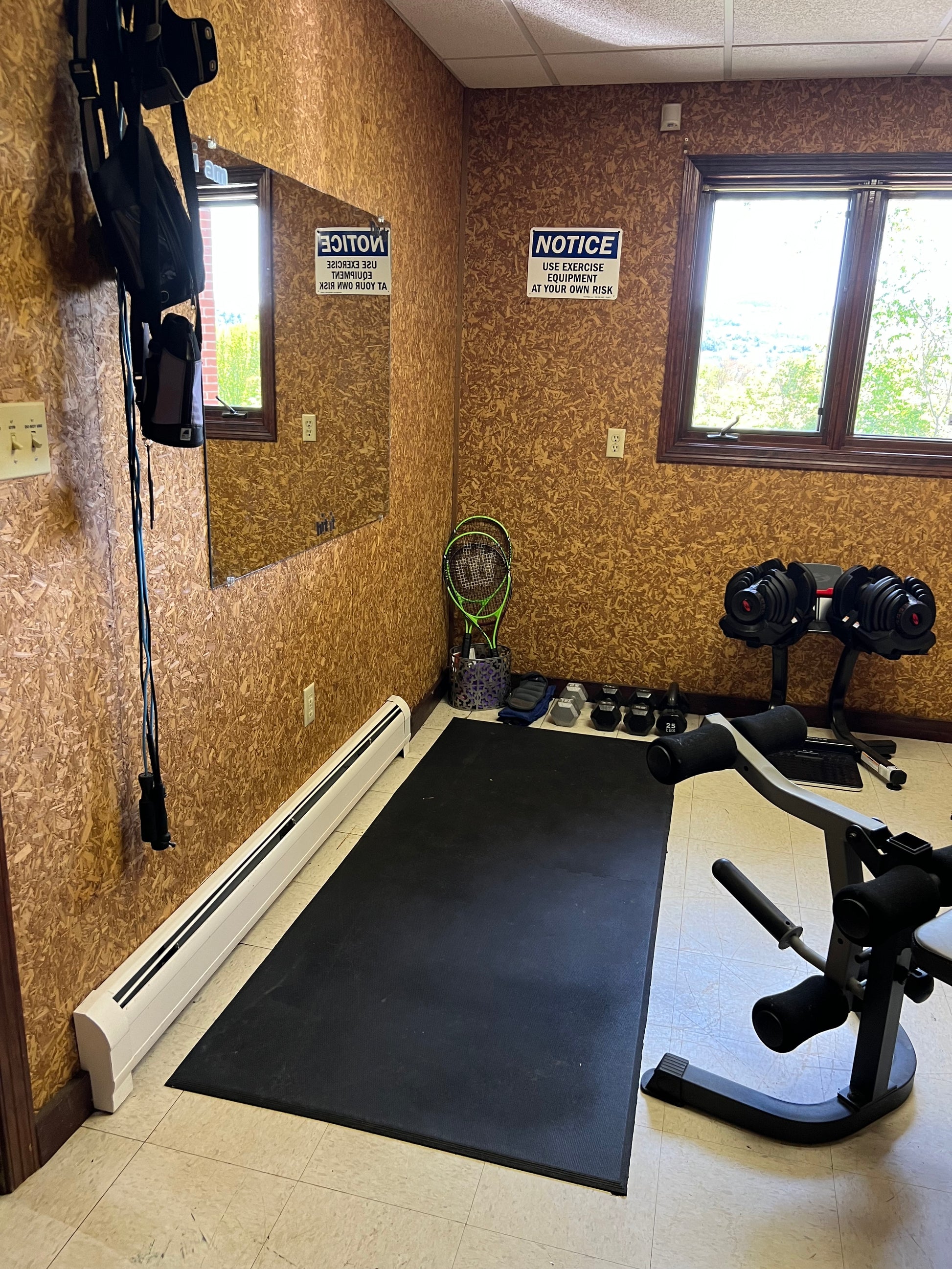 Gym room with exercise equipment on cork flooring