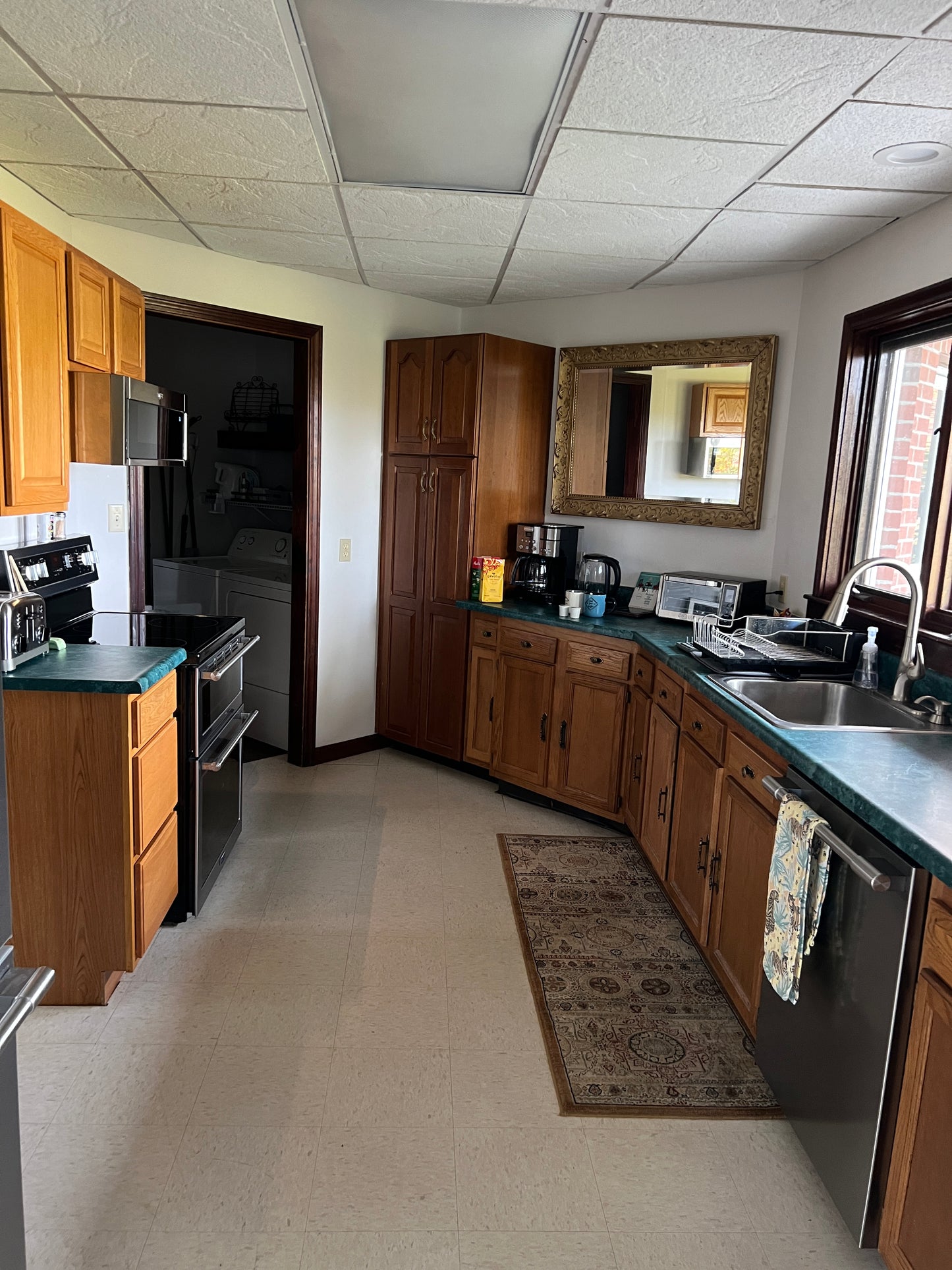 Kitchen interior with wooden cabinets and a tiled wall.