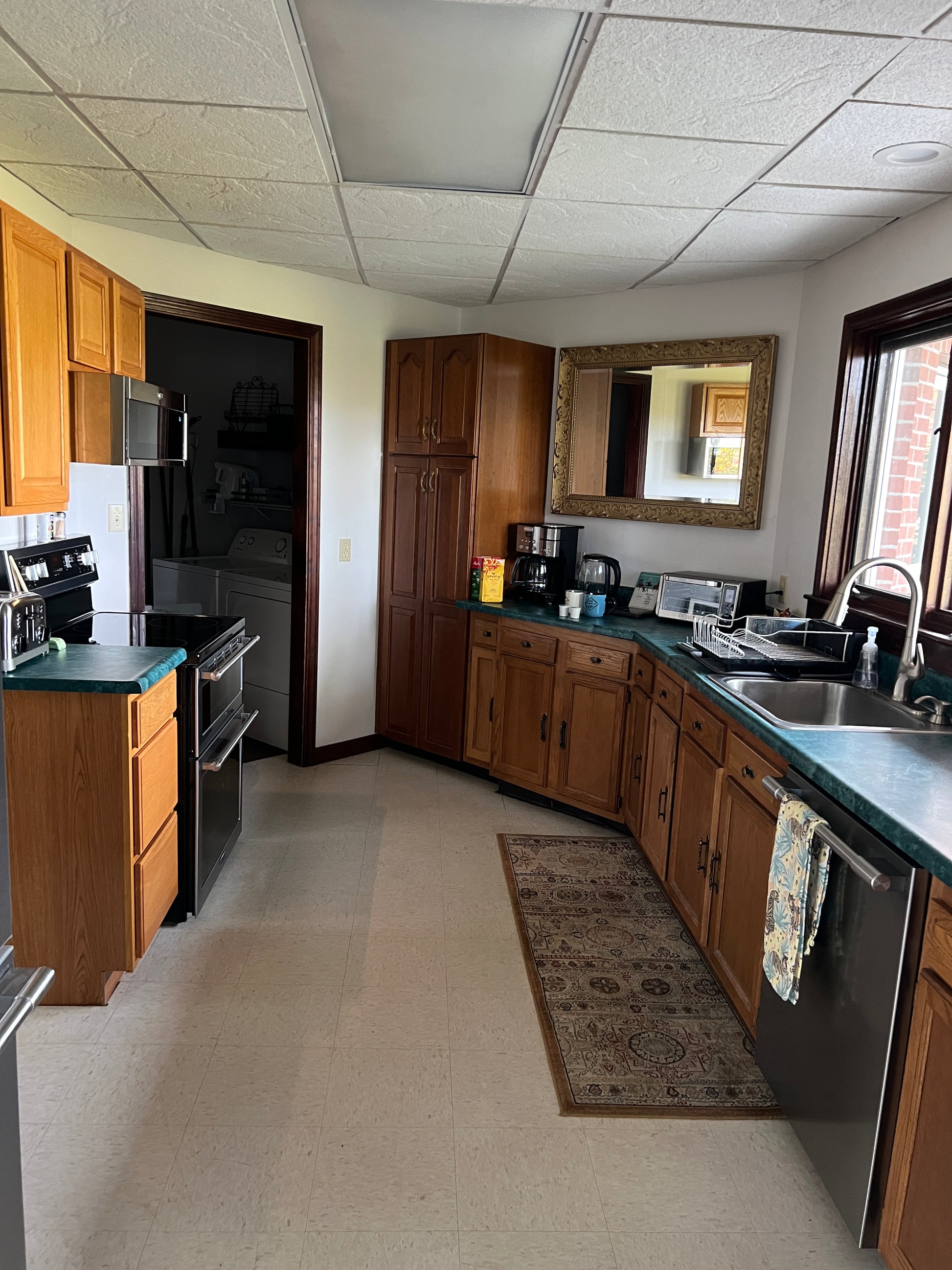 Kitchen interior with wooden cabinets and a tiled wall.