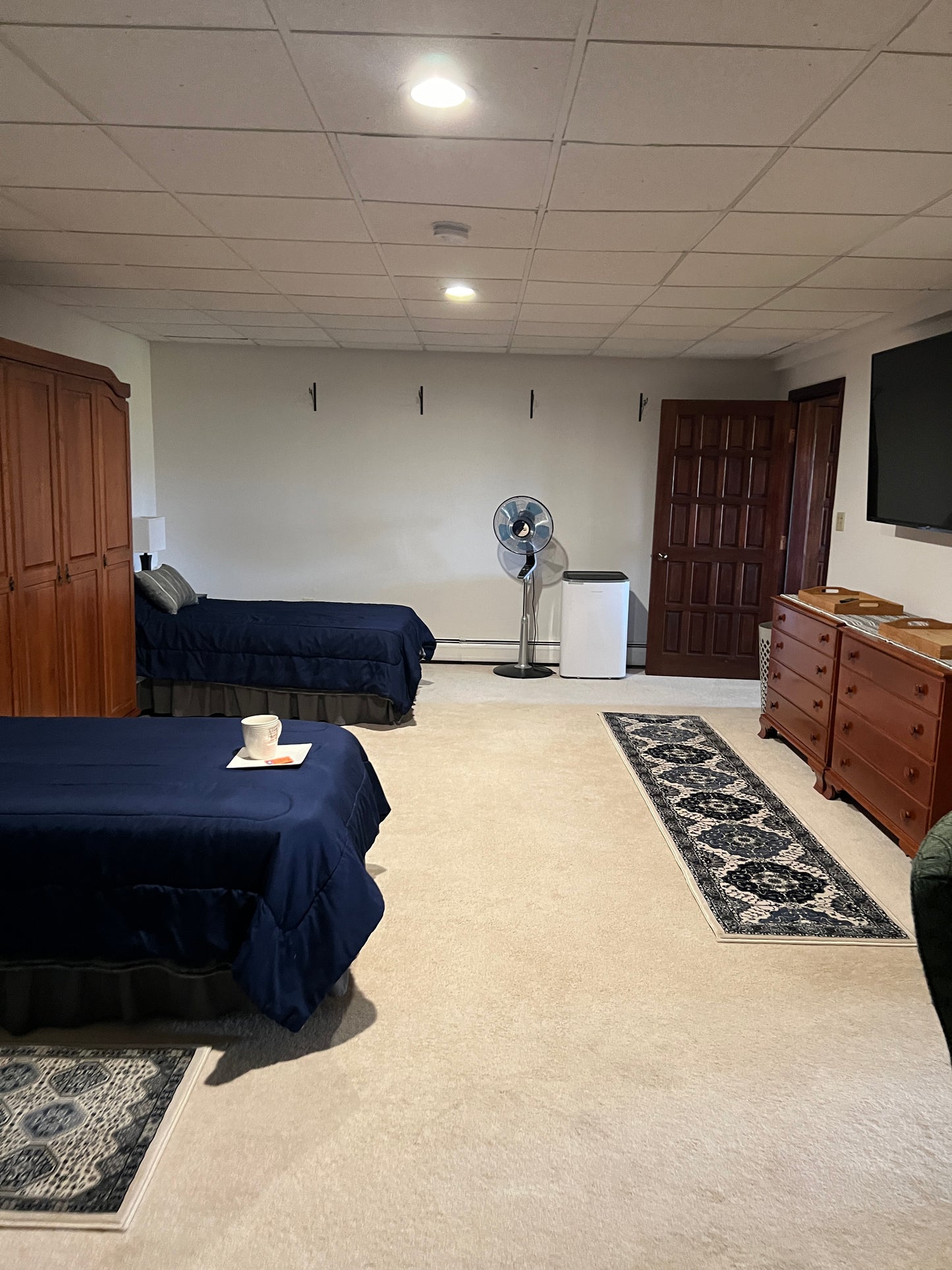 Rental suite bedroom two twin beds wardrobe entrance to gym.