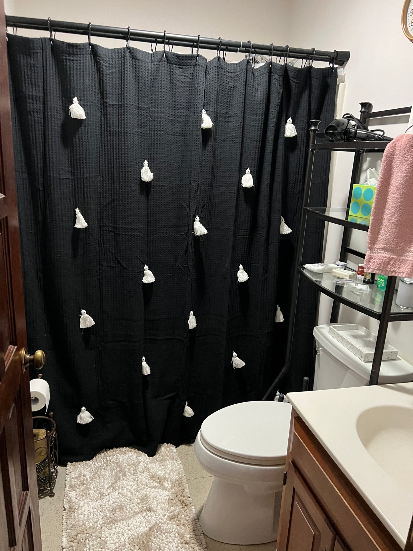 Black curtain with white floral patterns in a bathroom setting Nature View NH Estate