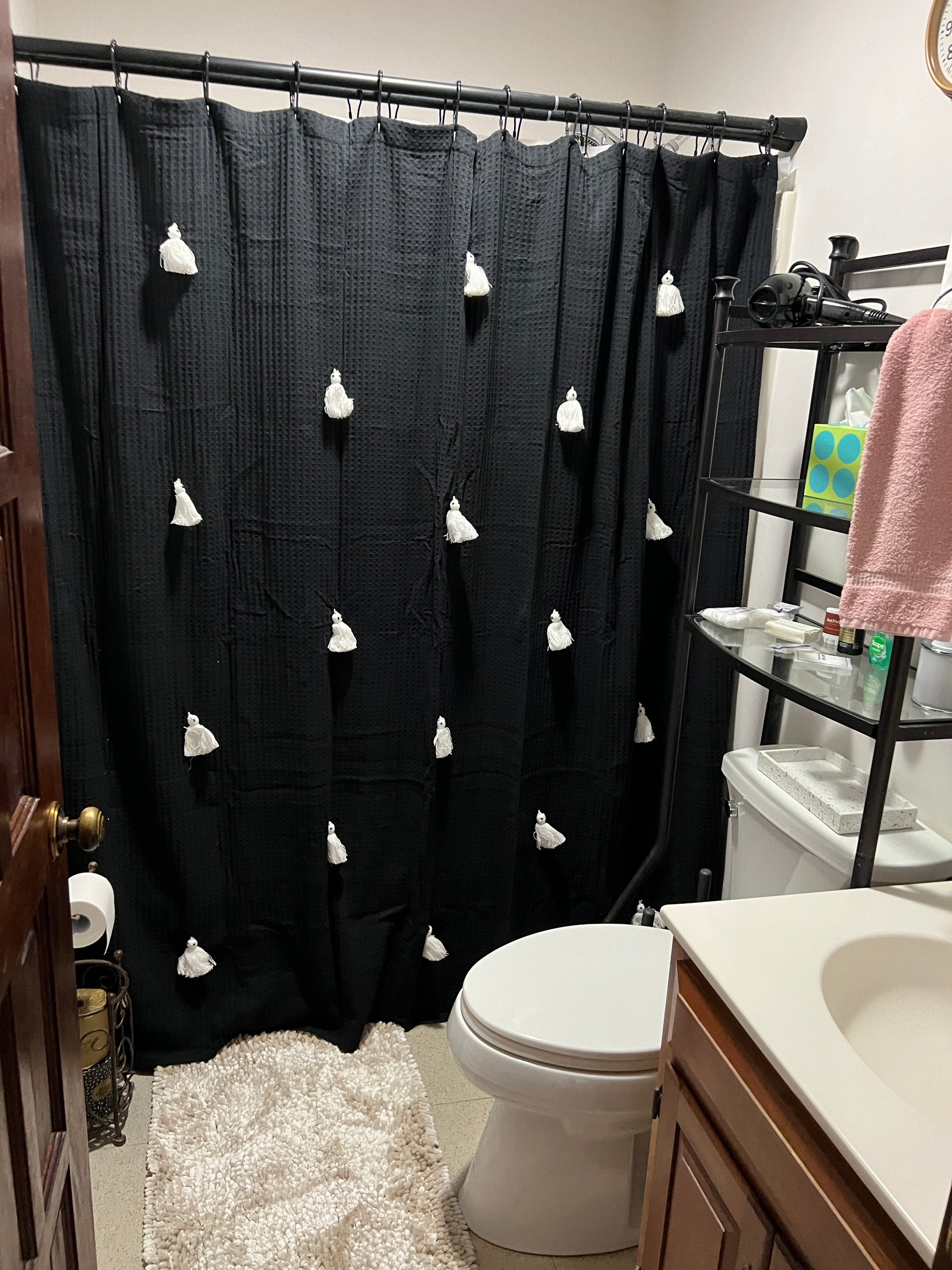 Black curtain with white floral patterns in a bathroom setting Nature View NH Estate