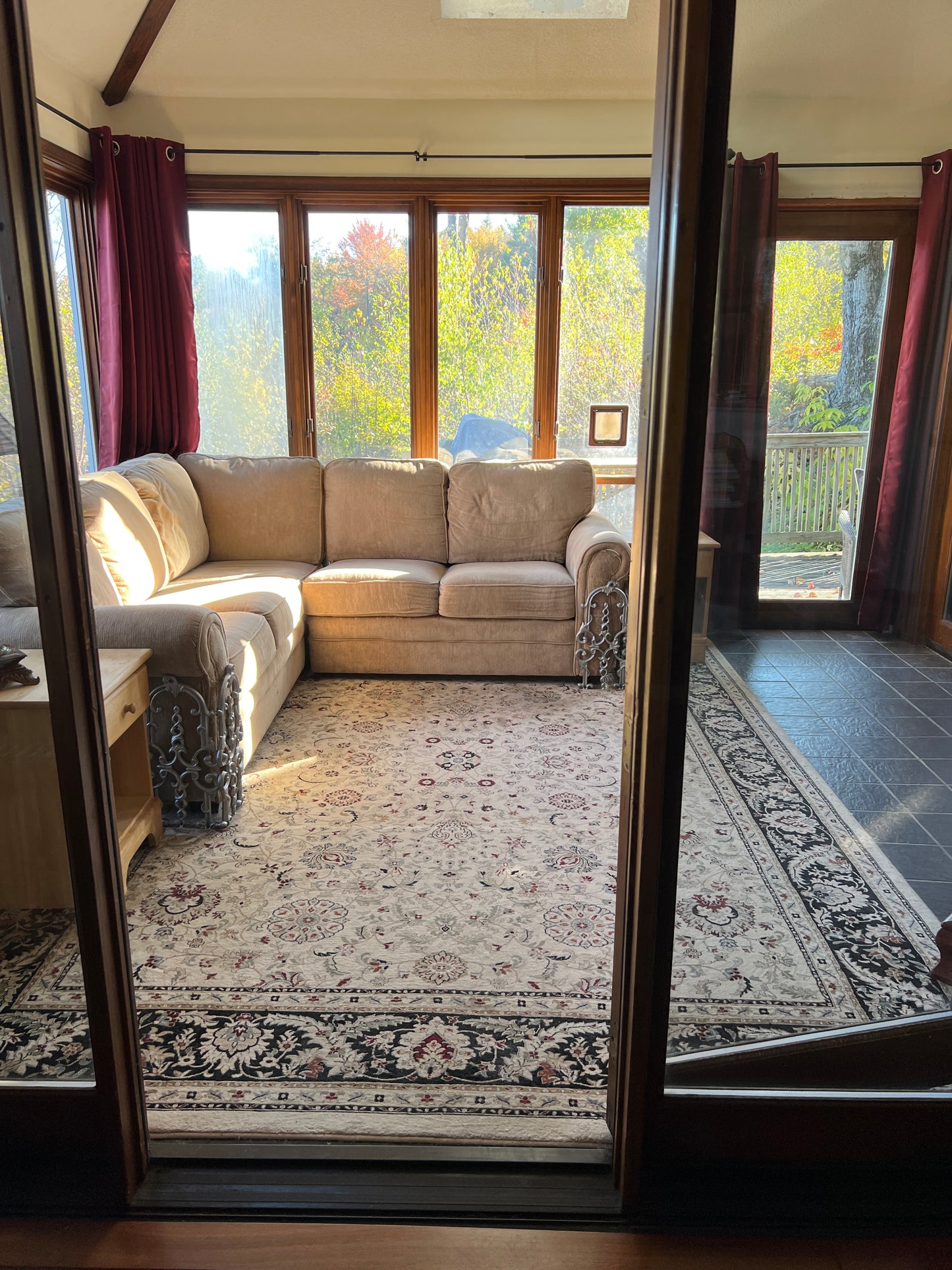  sofa in a room with a patterned rug and large windows