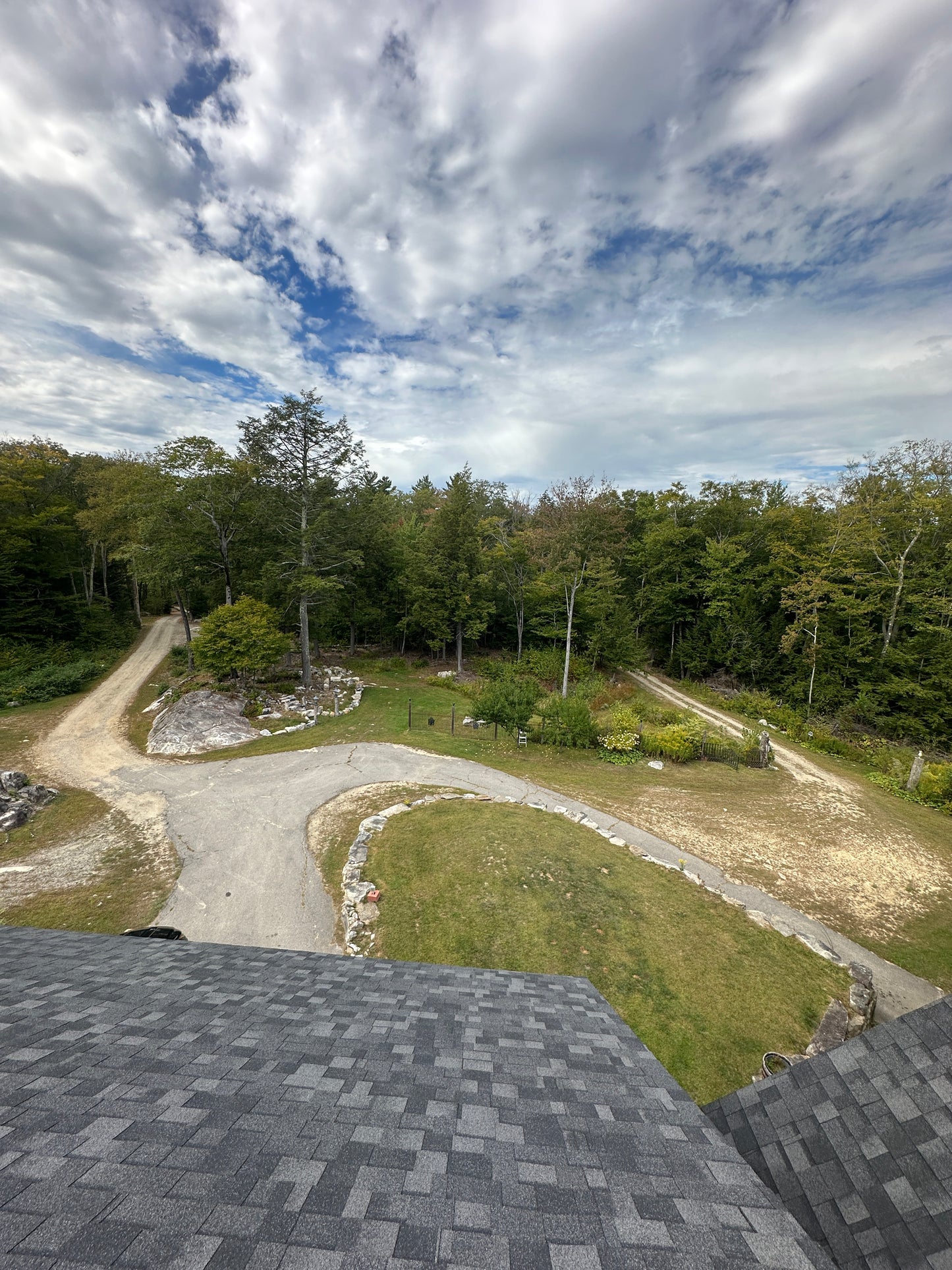 Driveway view  from roof  top edge with trees and sky