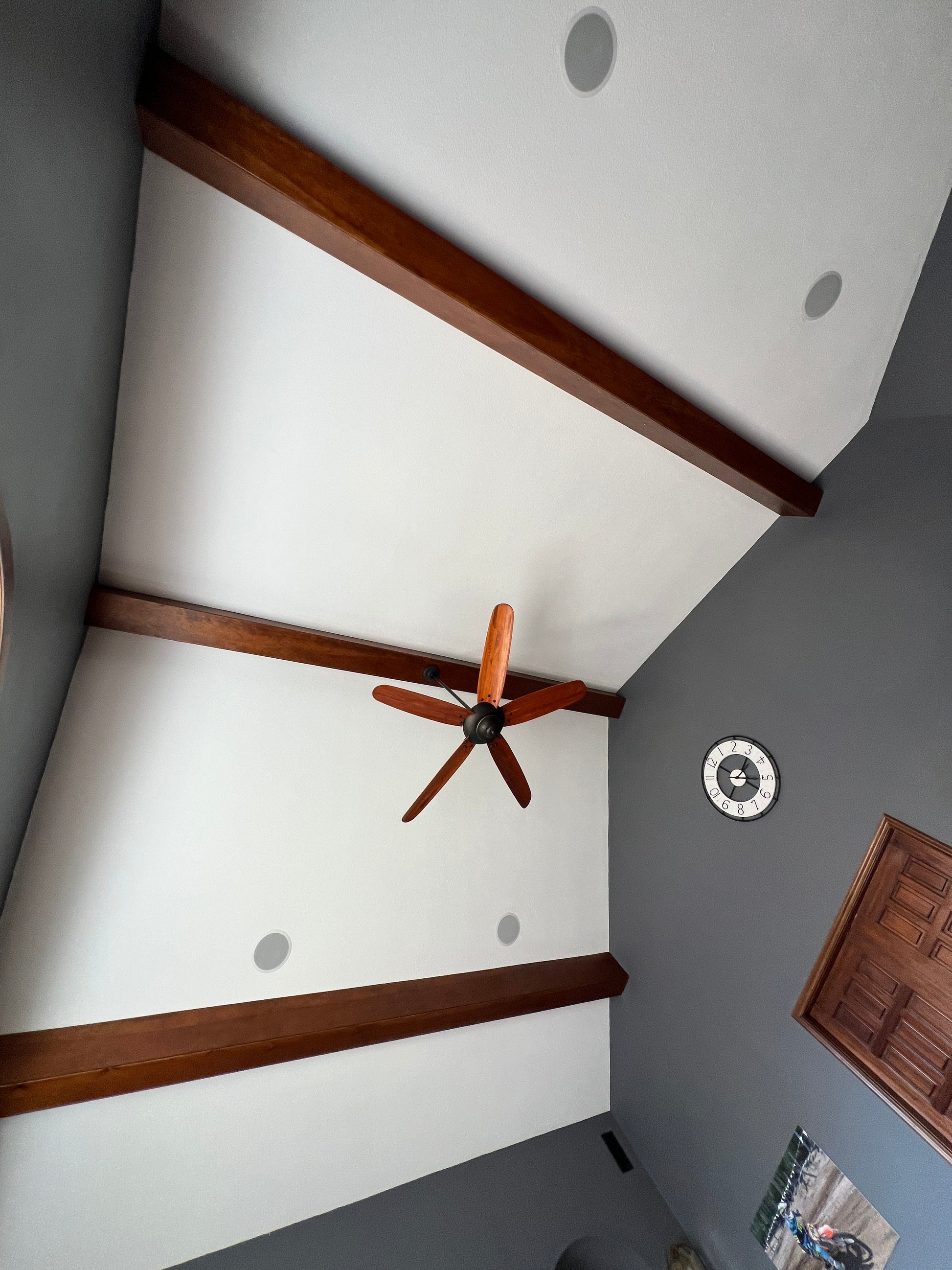Ceiling with wooden beams and a ceiling fan Theater sound with Dolby Atmos and Sonance Speakers