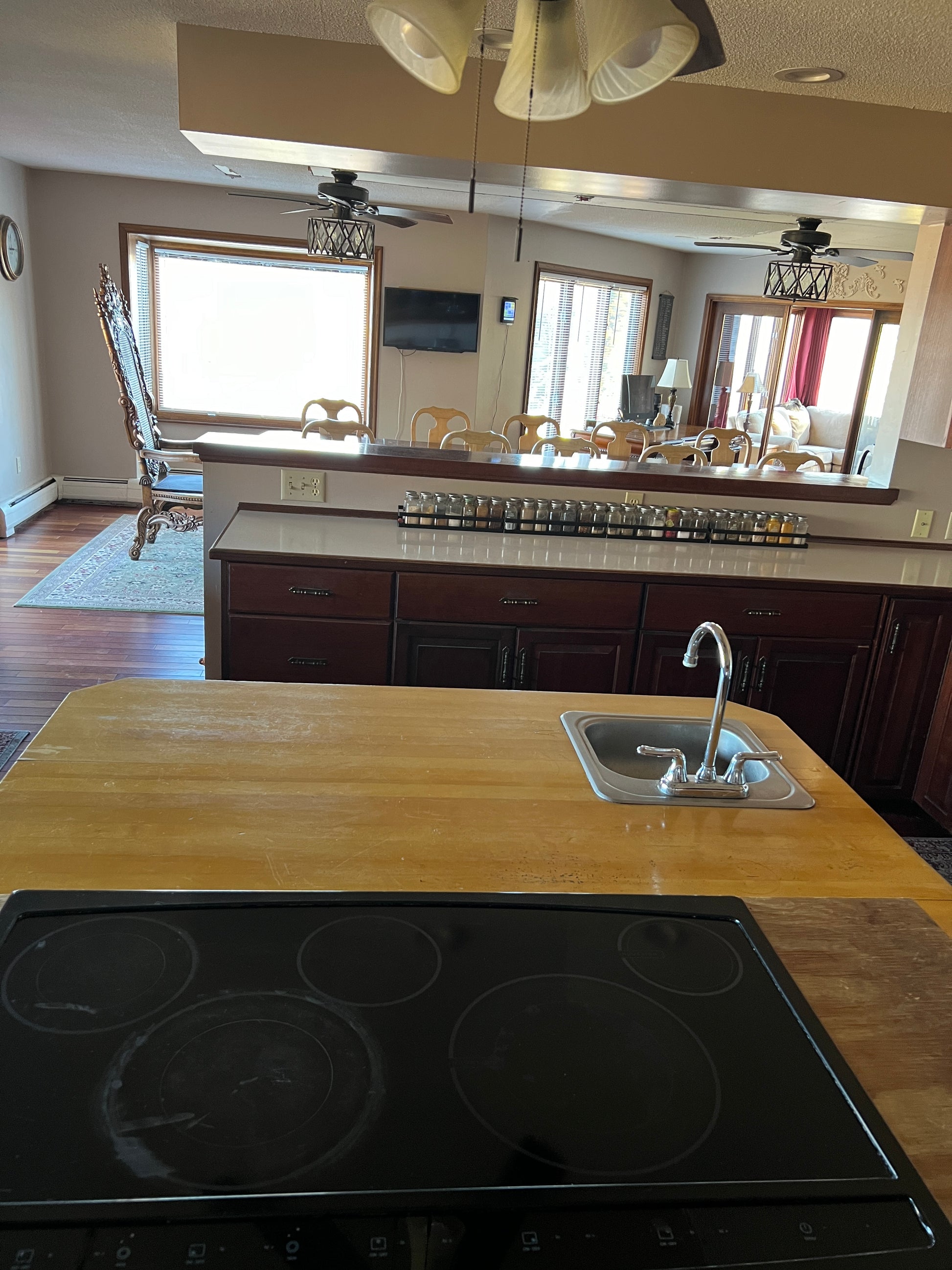 Kitchen with wooden countertop and black stovetop