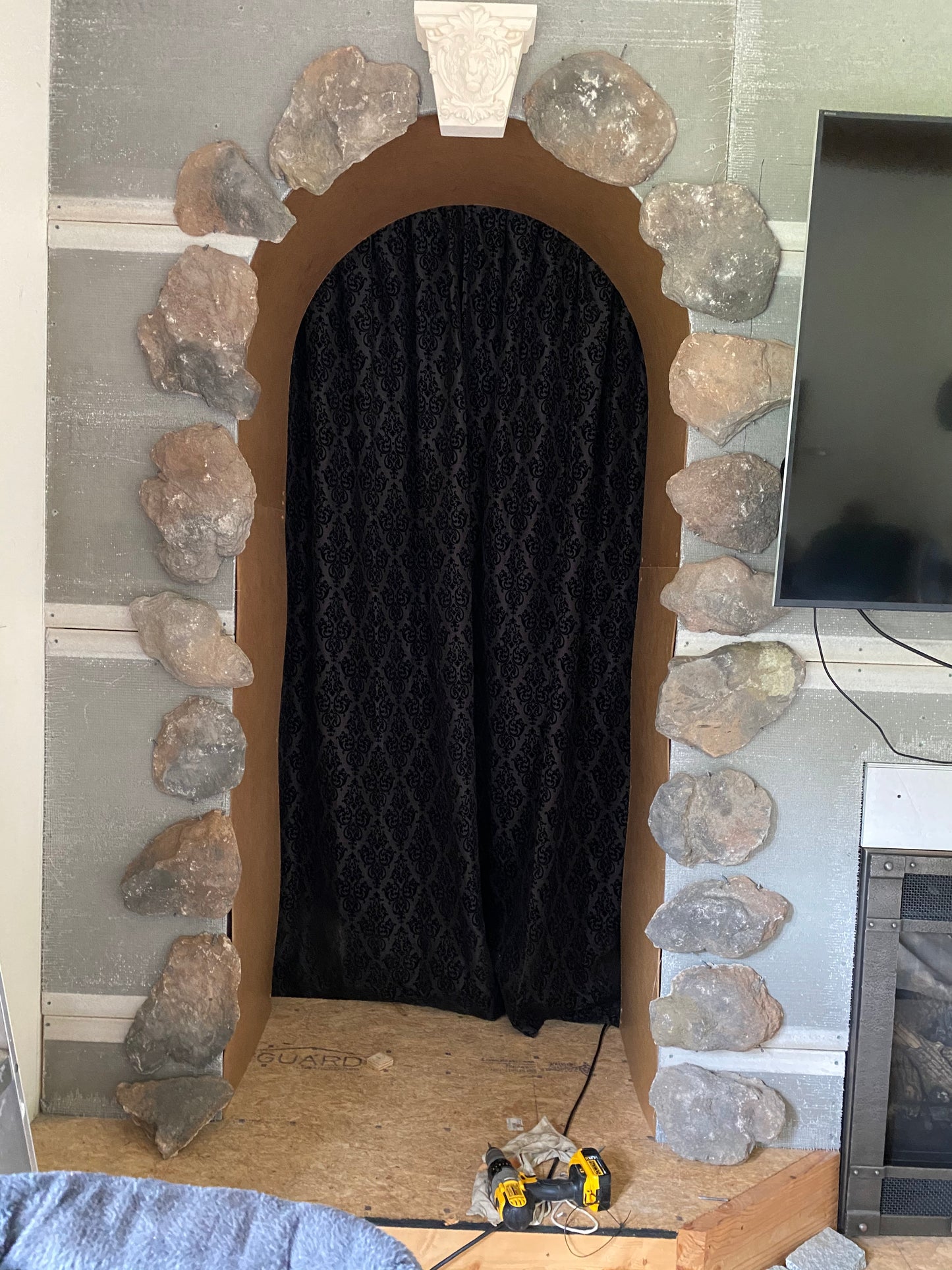 Decorative stone archway with a black curtain inside
