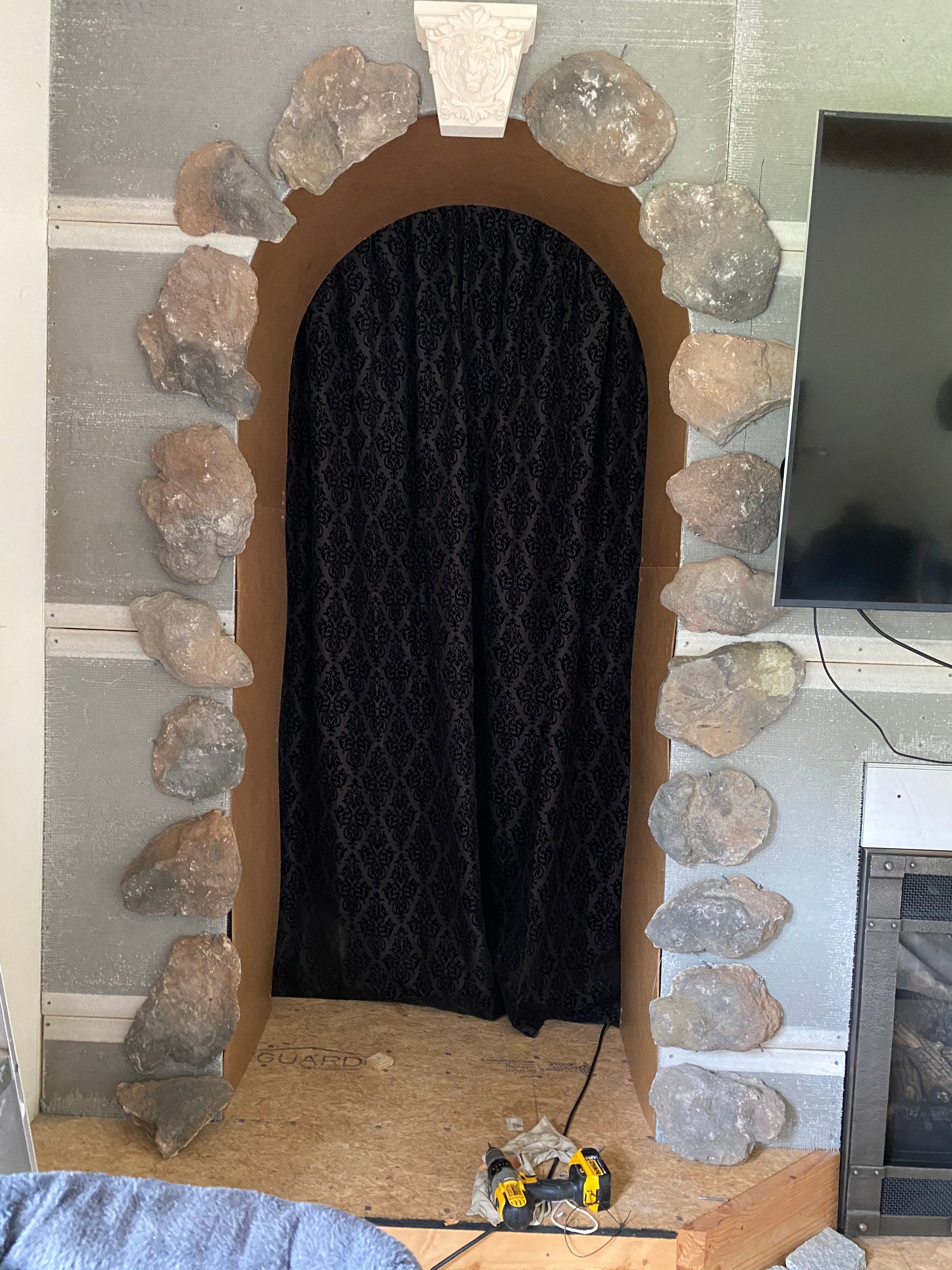 Decorative stone archway with a black curtain inside