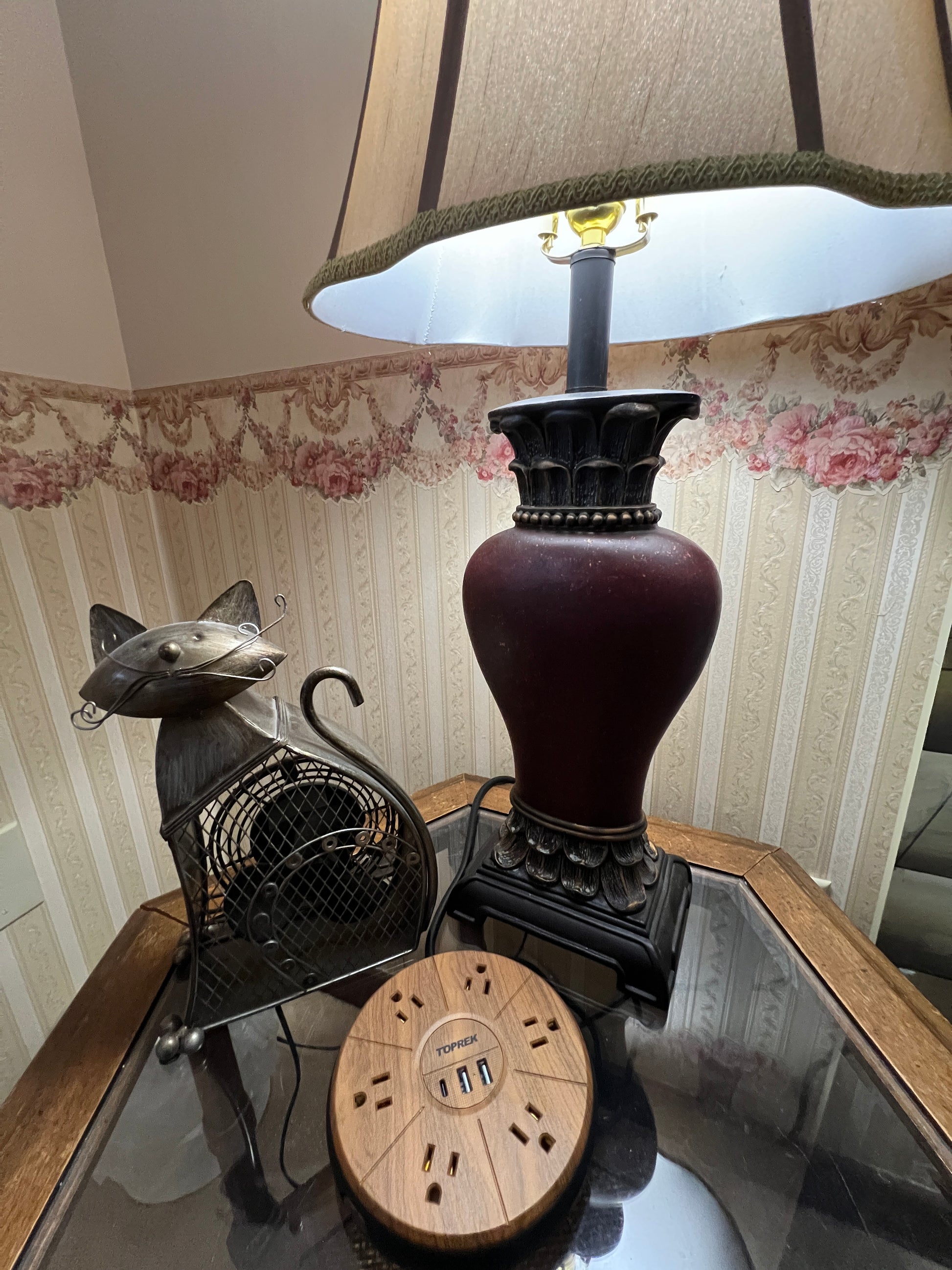 Vintage-style lamp with decorative base on a wooden surface