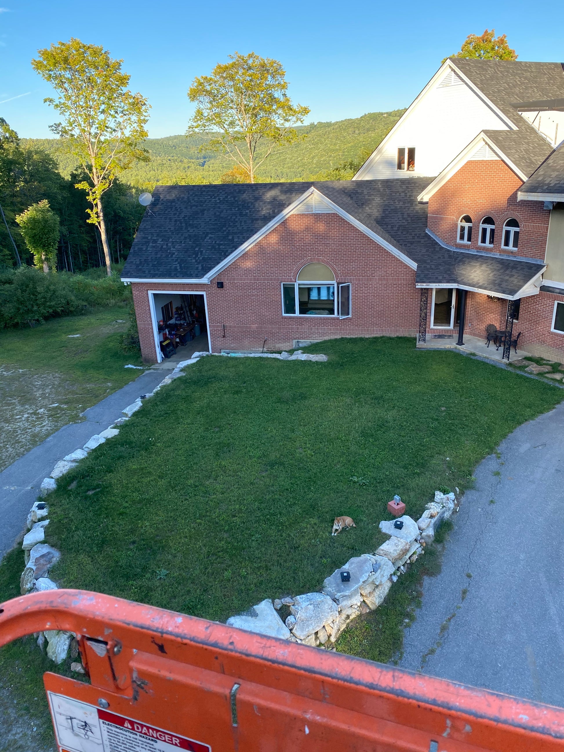 The nature view house with a front lawn , taken from an elevated perspective.