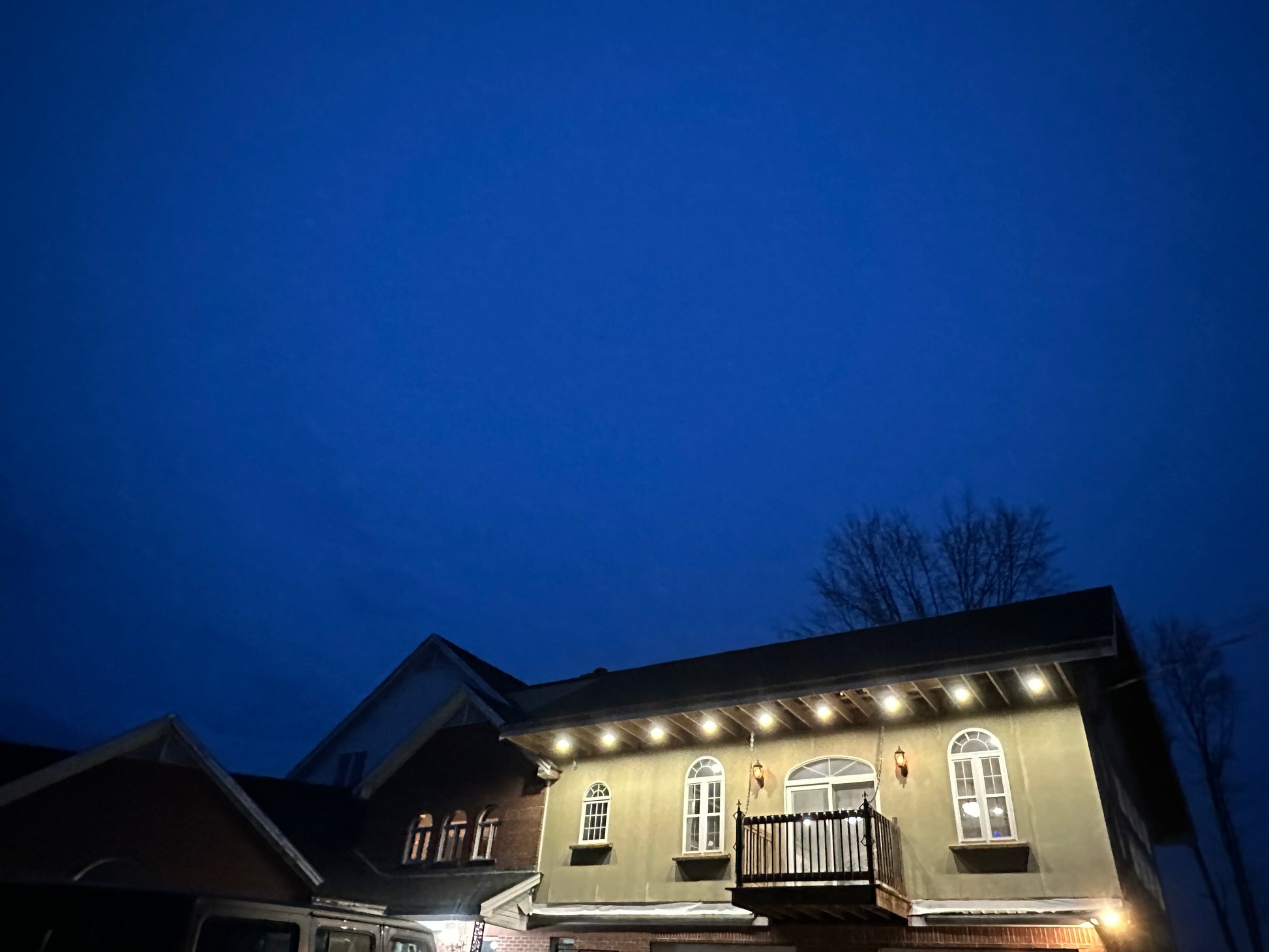 House exterior at night with lights on