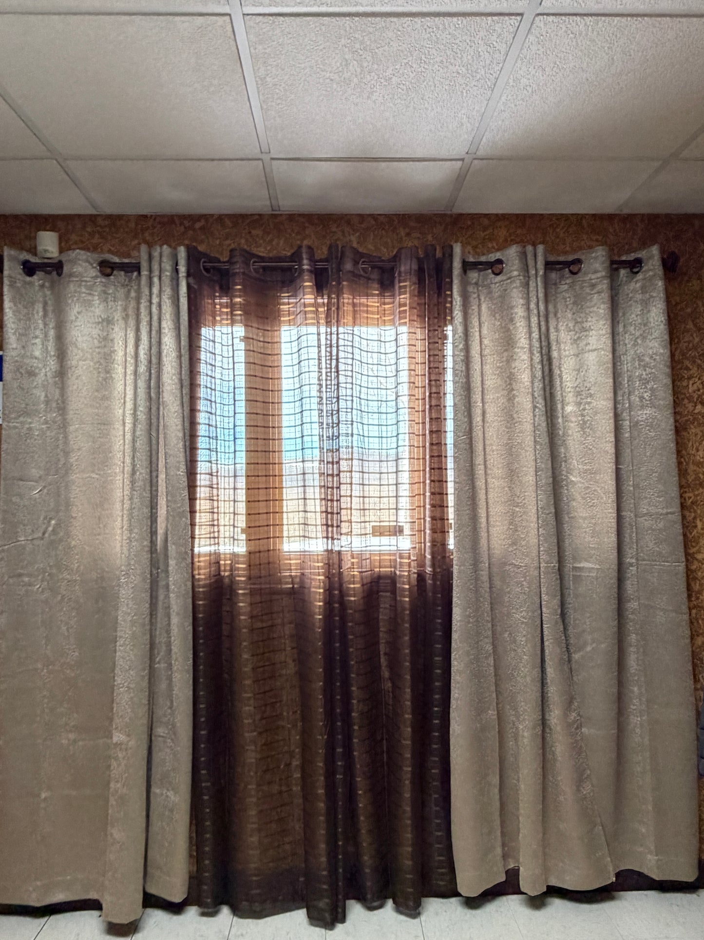 Stack of folded curtains against a tiled wall