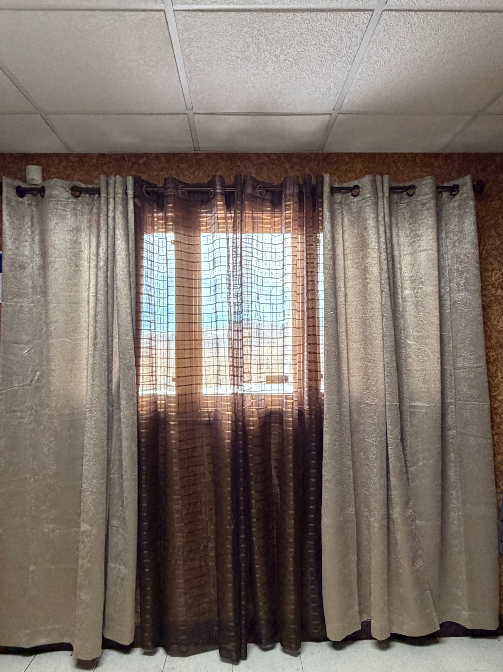 Stack of folded curtains against a tiled wall
