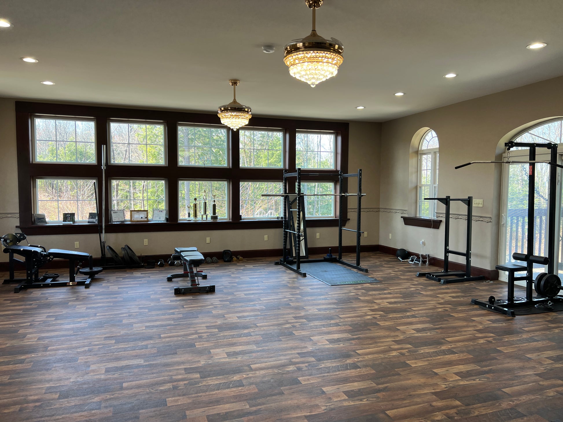 Gym interior with exercise equipment and large windows. Flex spaces Nature View NH Estate