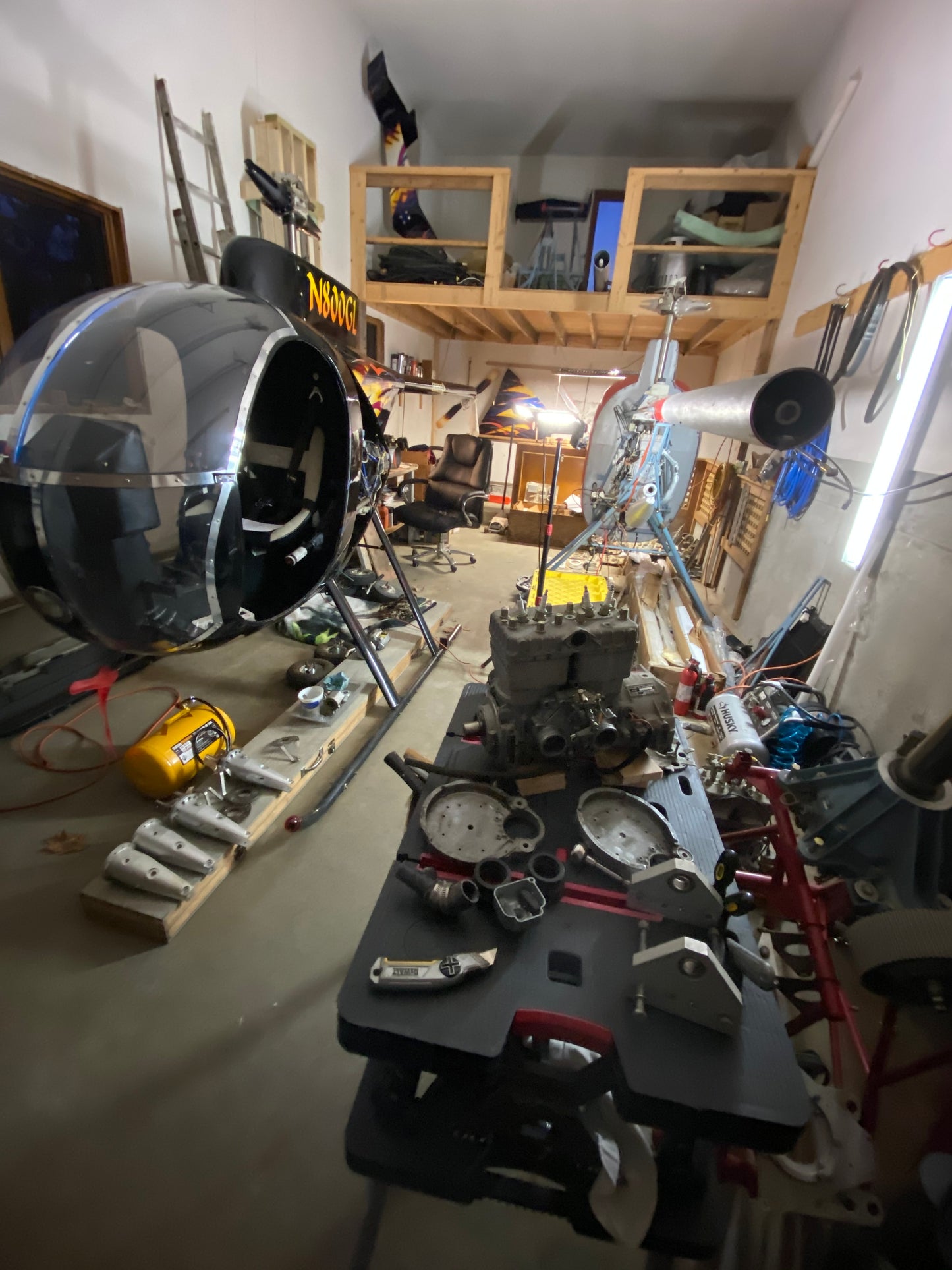 Complex mechanical setup with various components in a workshop setting