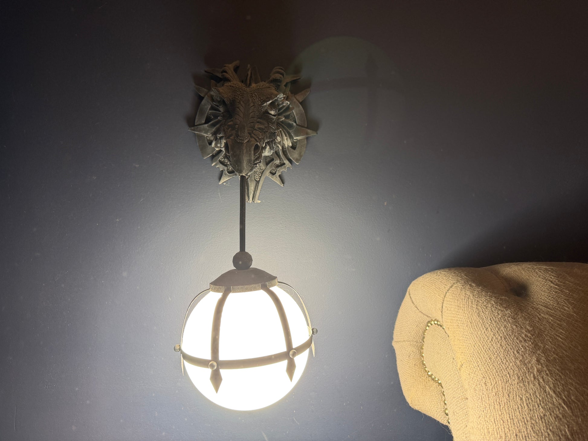 Wall sconce dragon head with globe  on each side of bed
