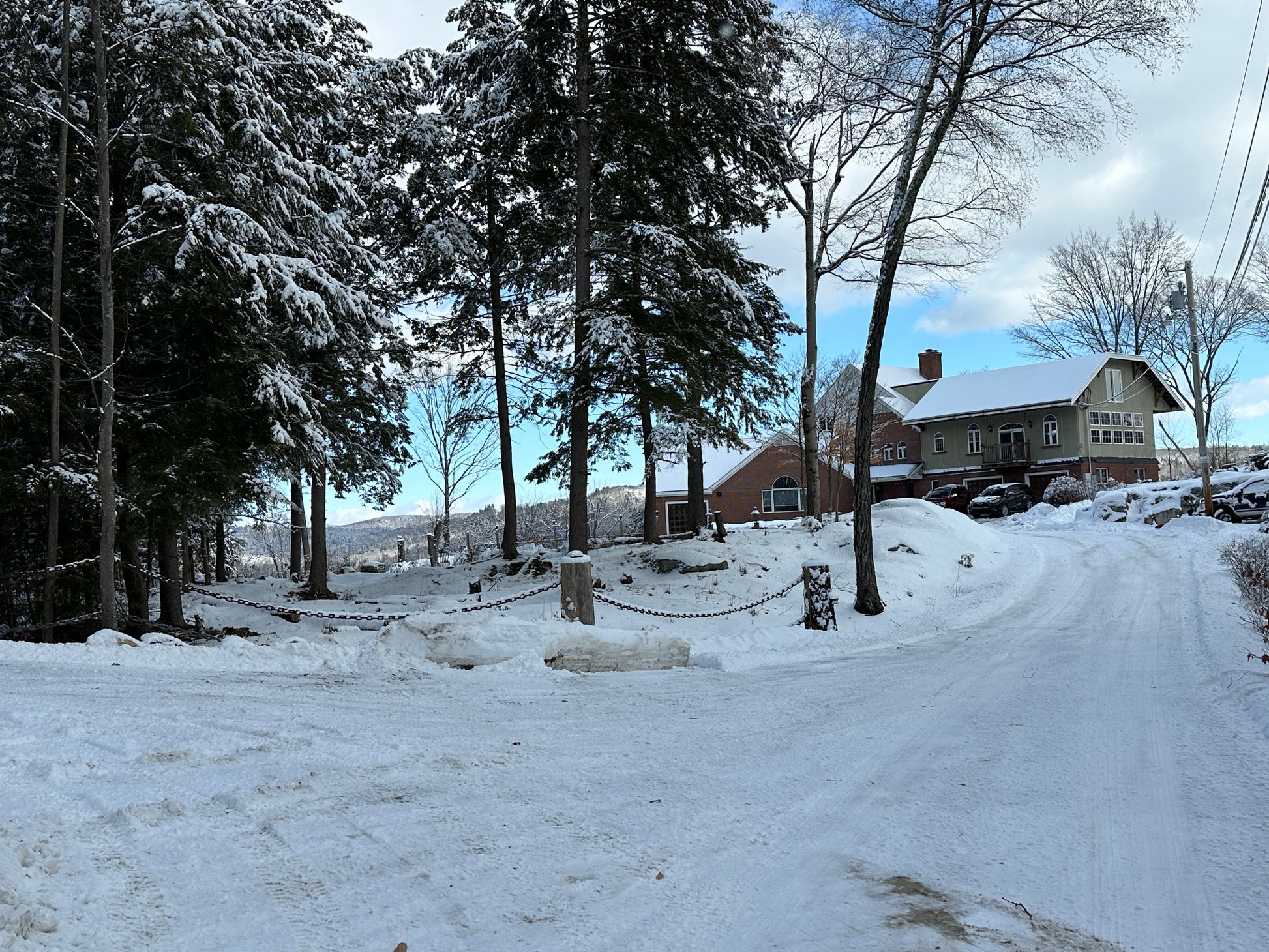 Snowy landscape with a house and trees in the background Nature View NH Estate
