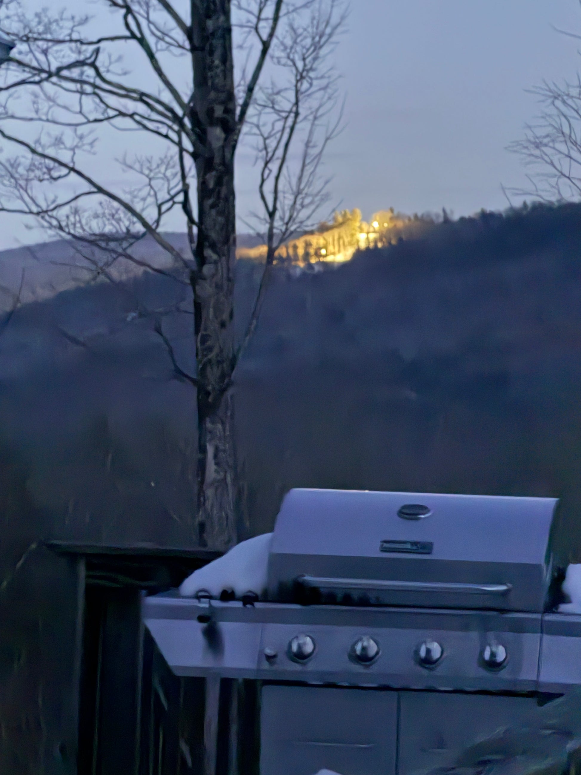 Grill with a ski slope lights reflection in the background