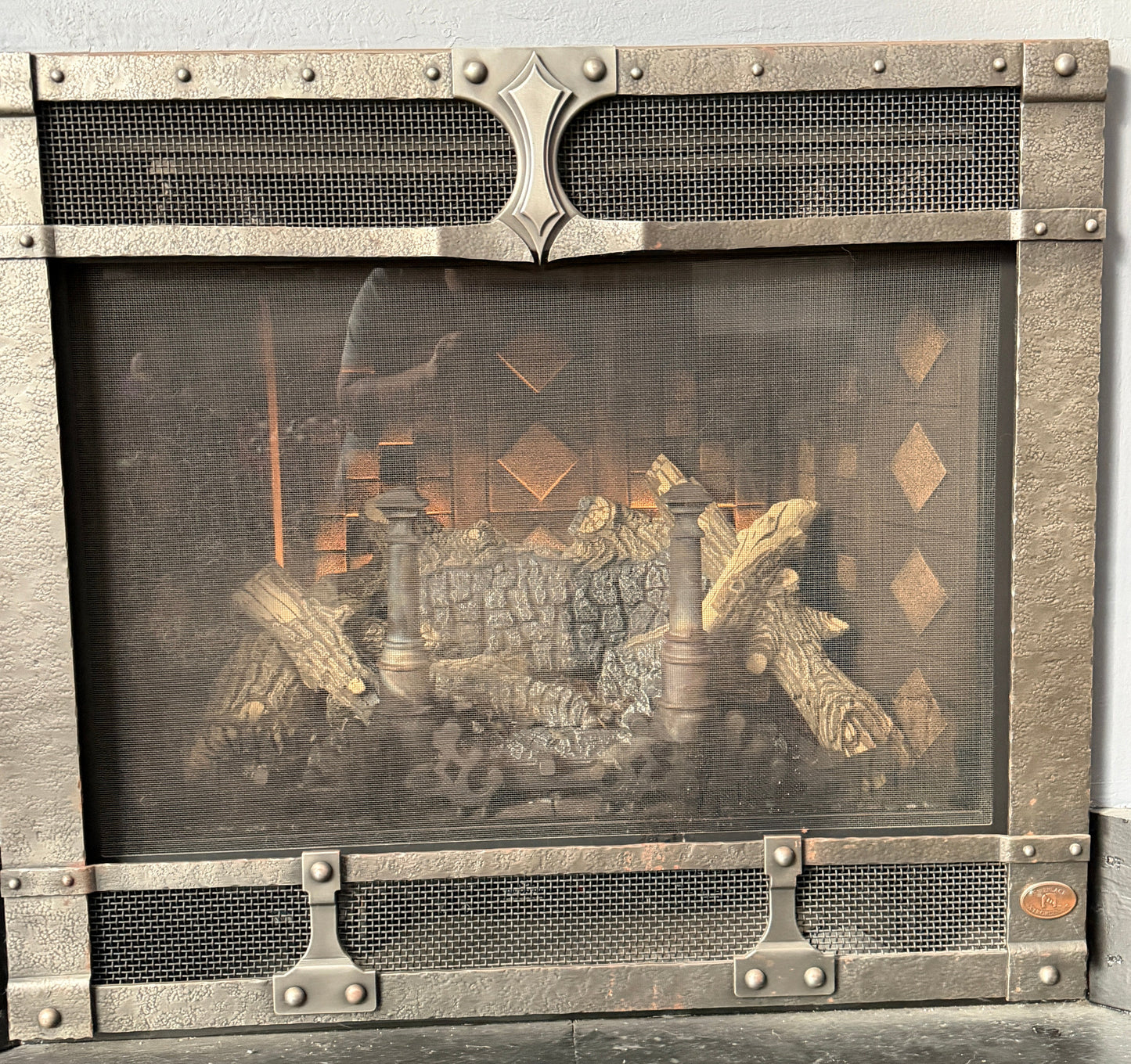Fireplace with decorative screen and fire inside